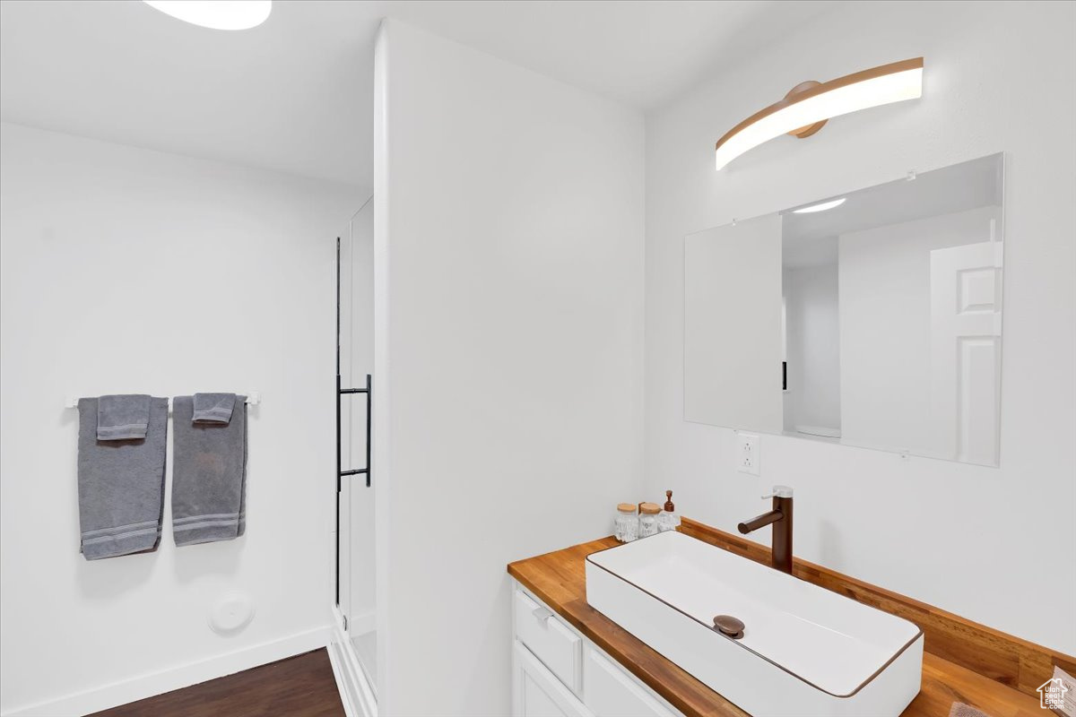 Bathroom with vanity and hardwood / wood-style floors