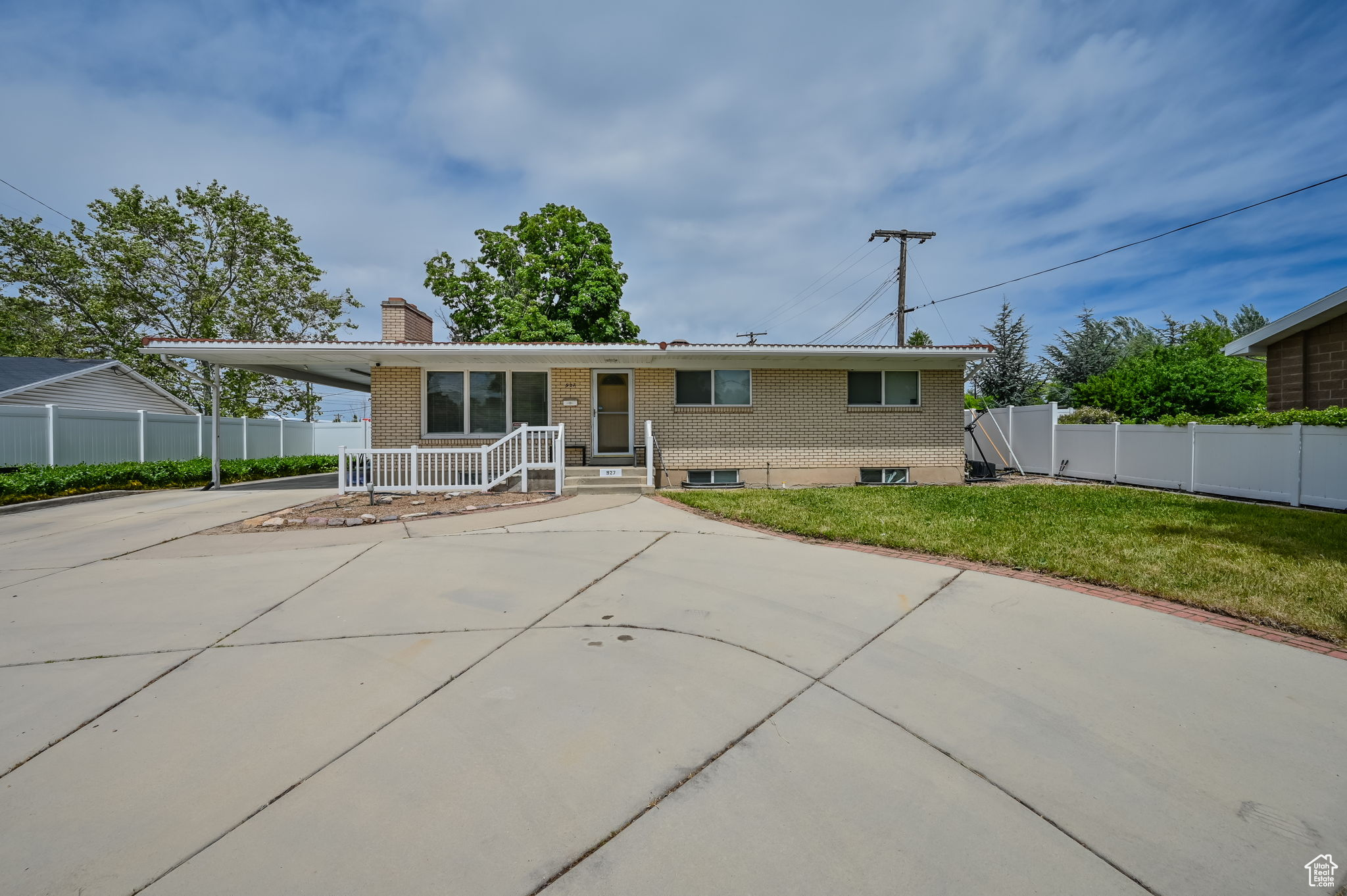 Ranch-style home featuring a front lawn and covered porch