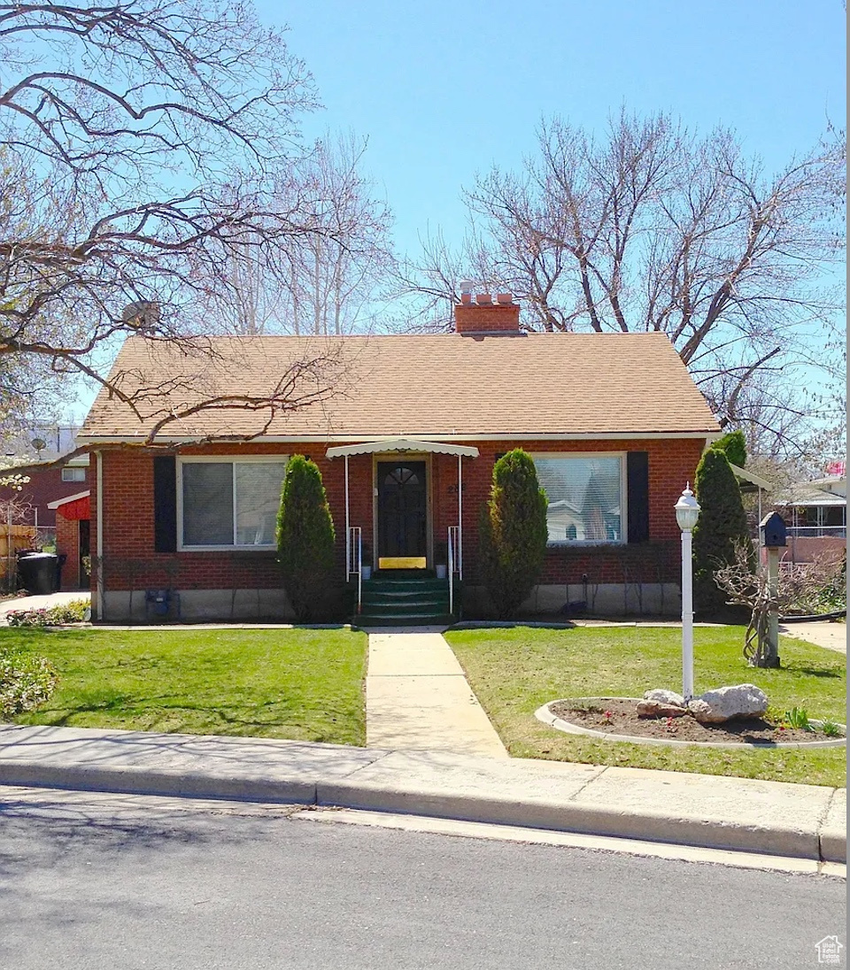 Single story home with a front lawn