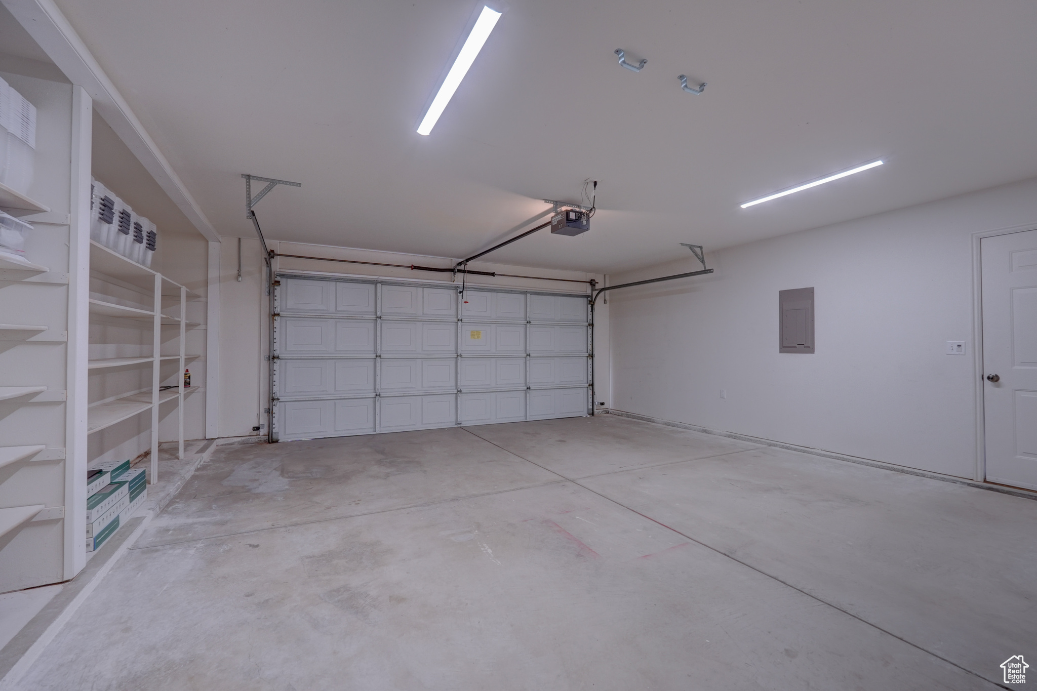 Garage with a garage door opener and electric panel