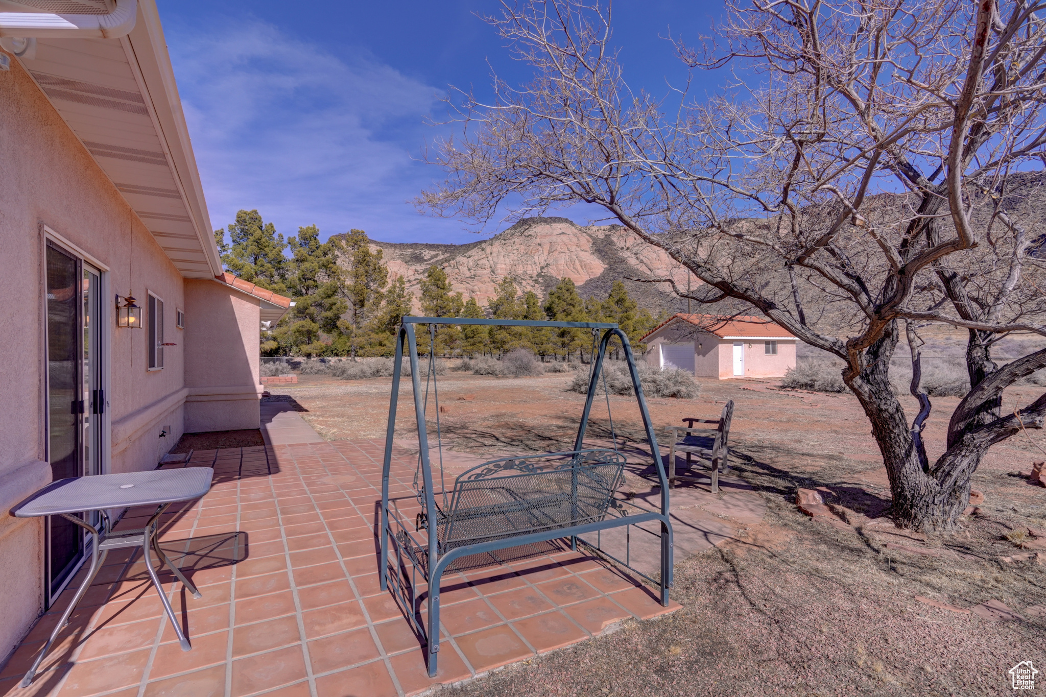 View of patio / terrace with a storage unit and a mountain view