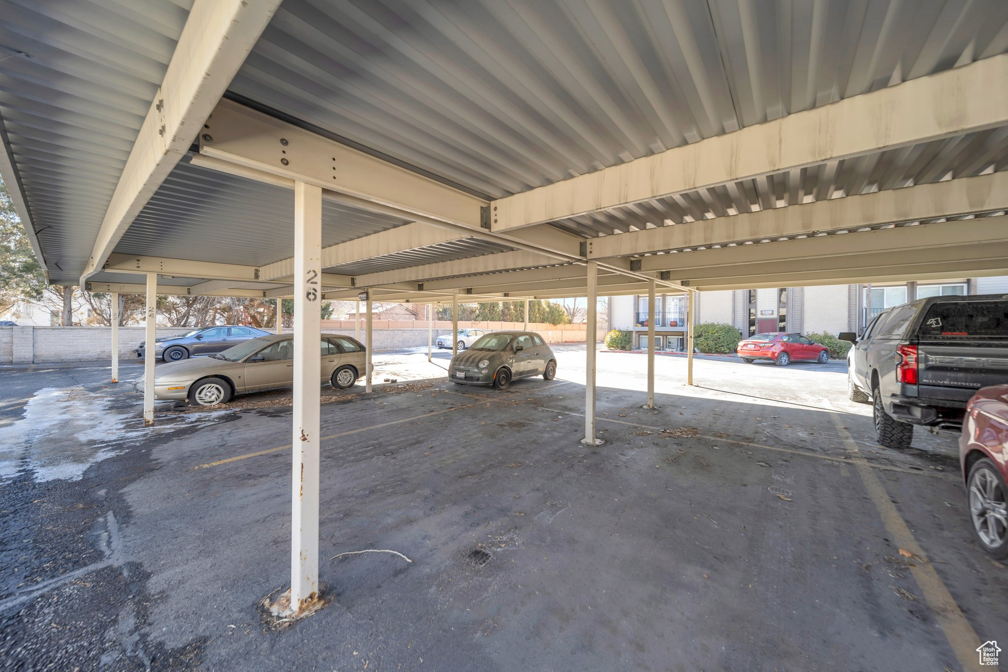 Garage featuring a carport