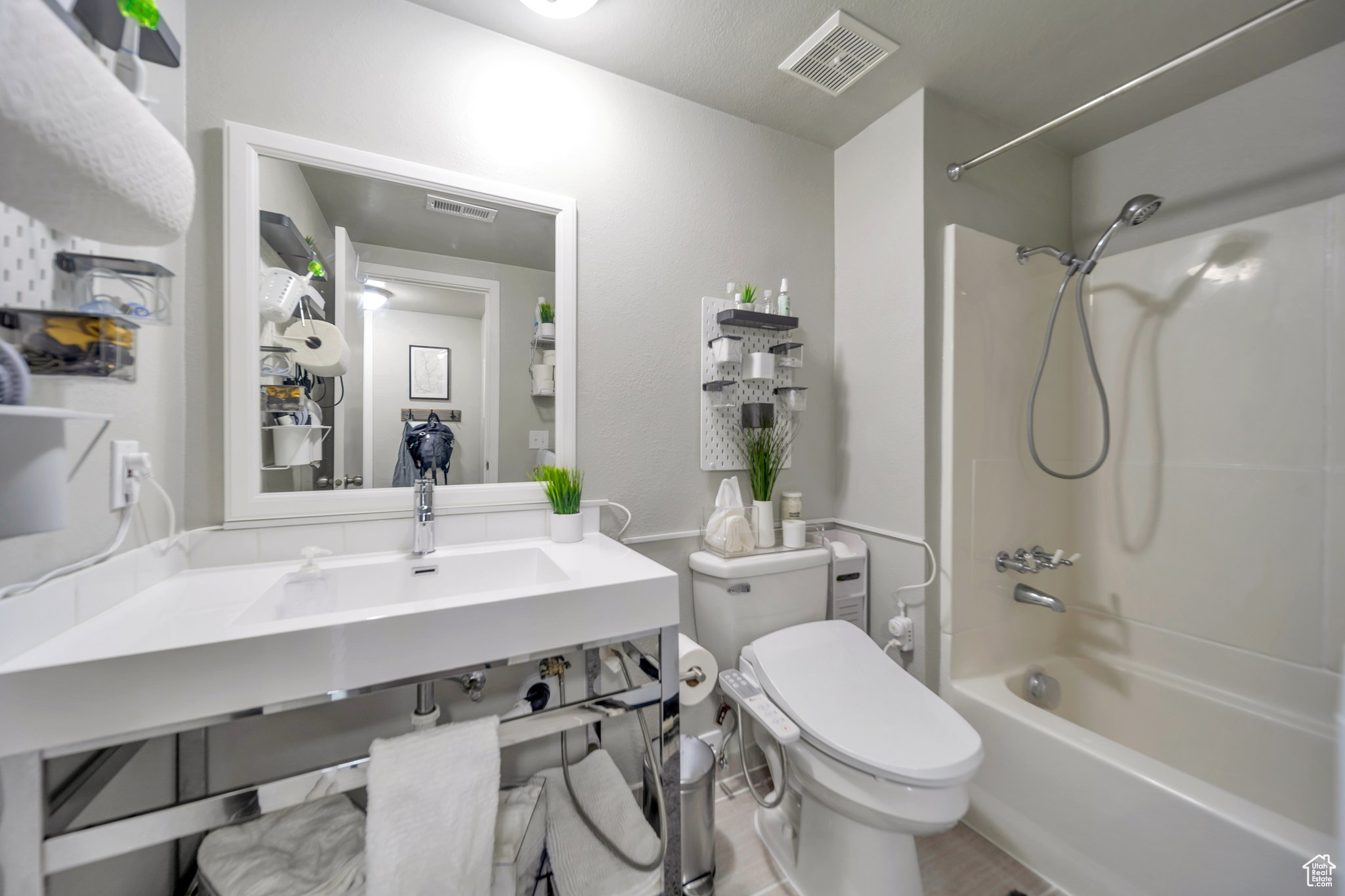 Full bathroom featuring sink, shower / bathtub combination, and toilet