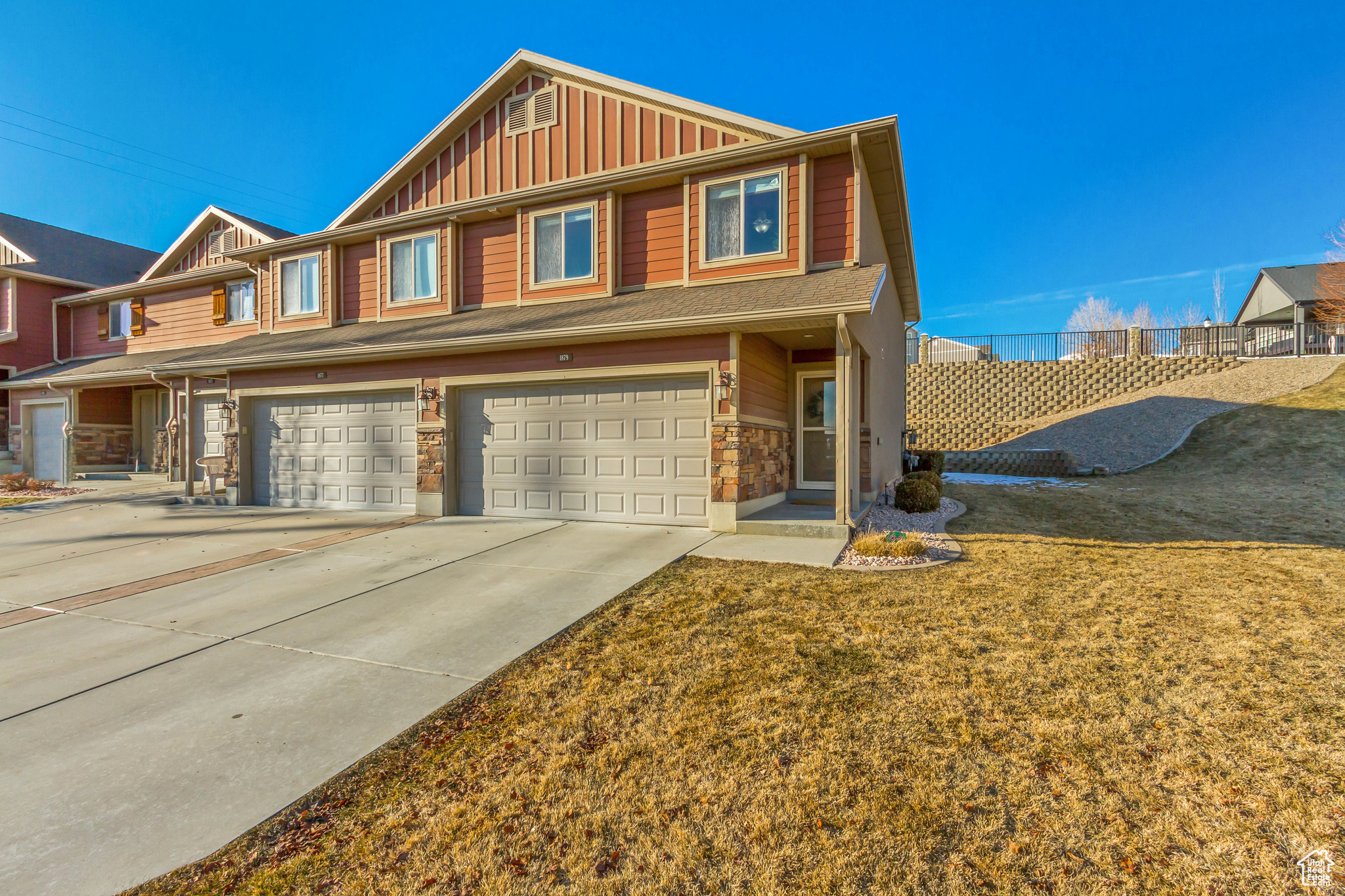 View of front of home featuring a garage and a front lawn