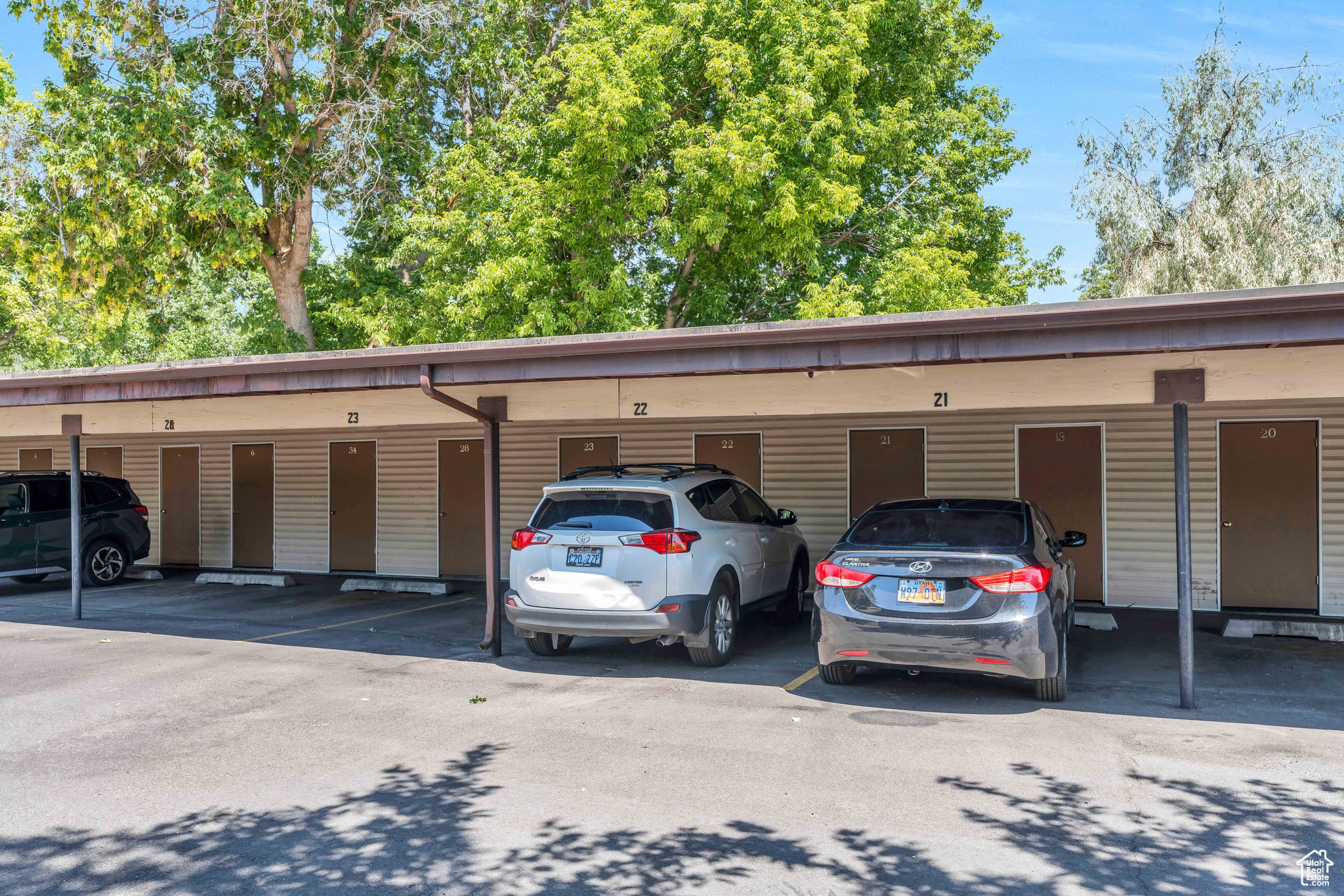 View of parking / parking lot featuring a carport