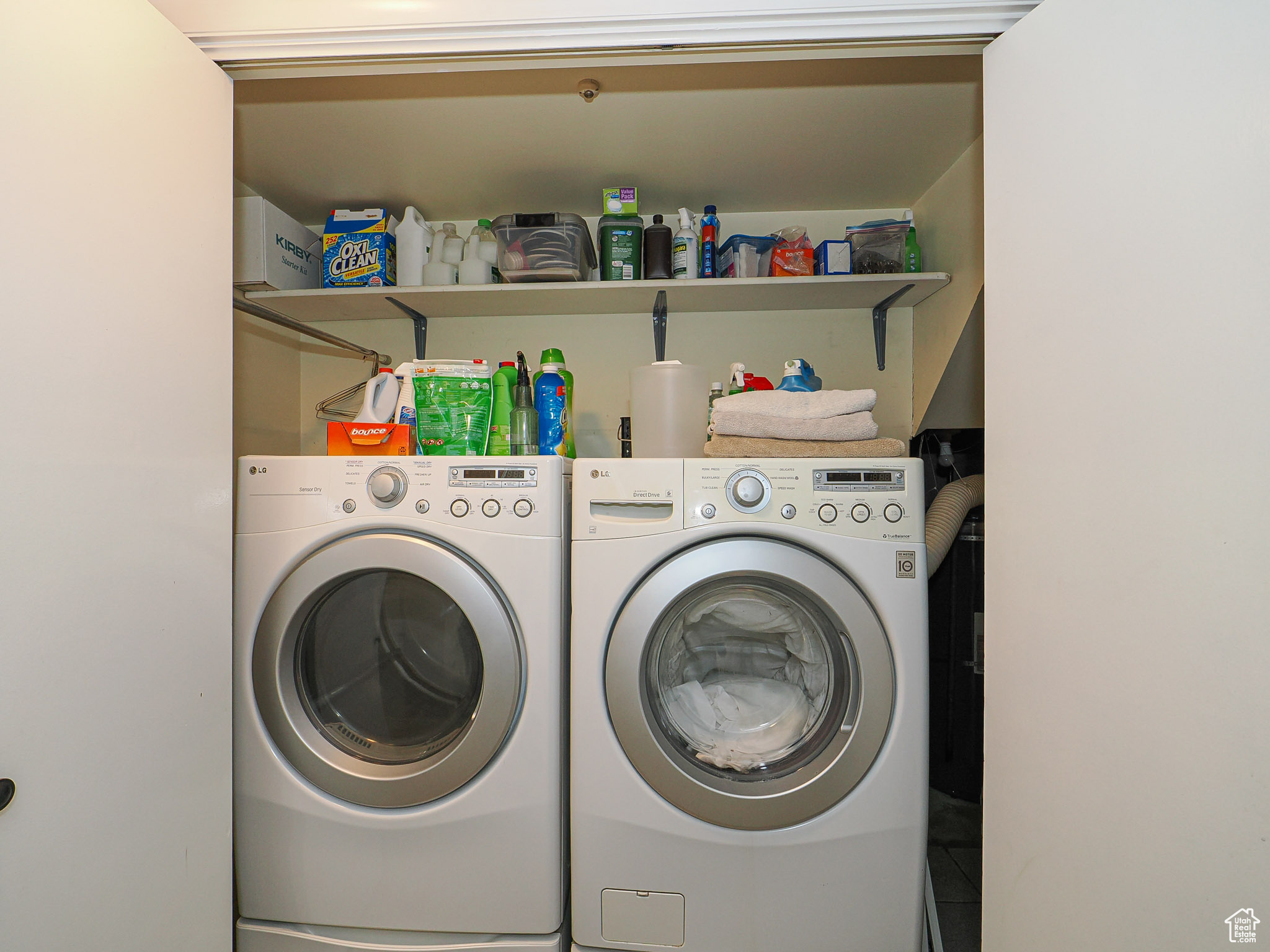 Clothes washing area featuring washer and dryer