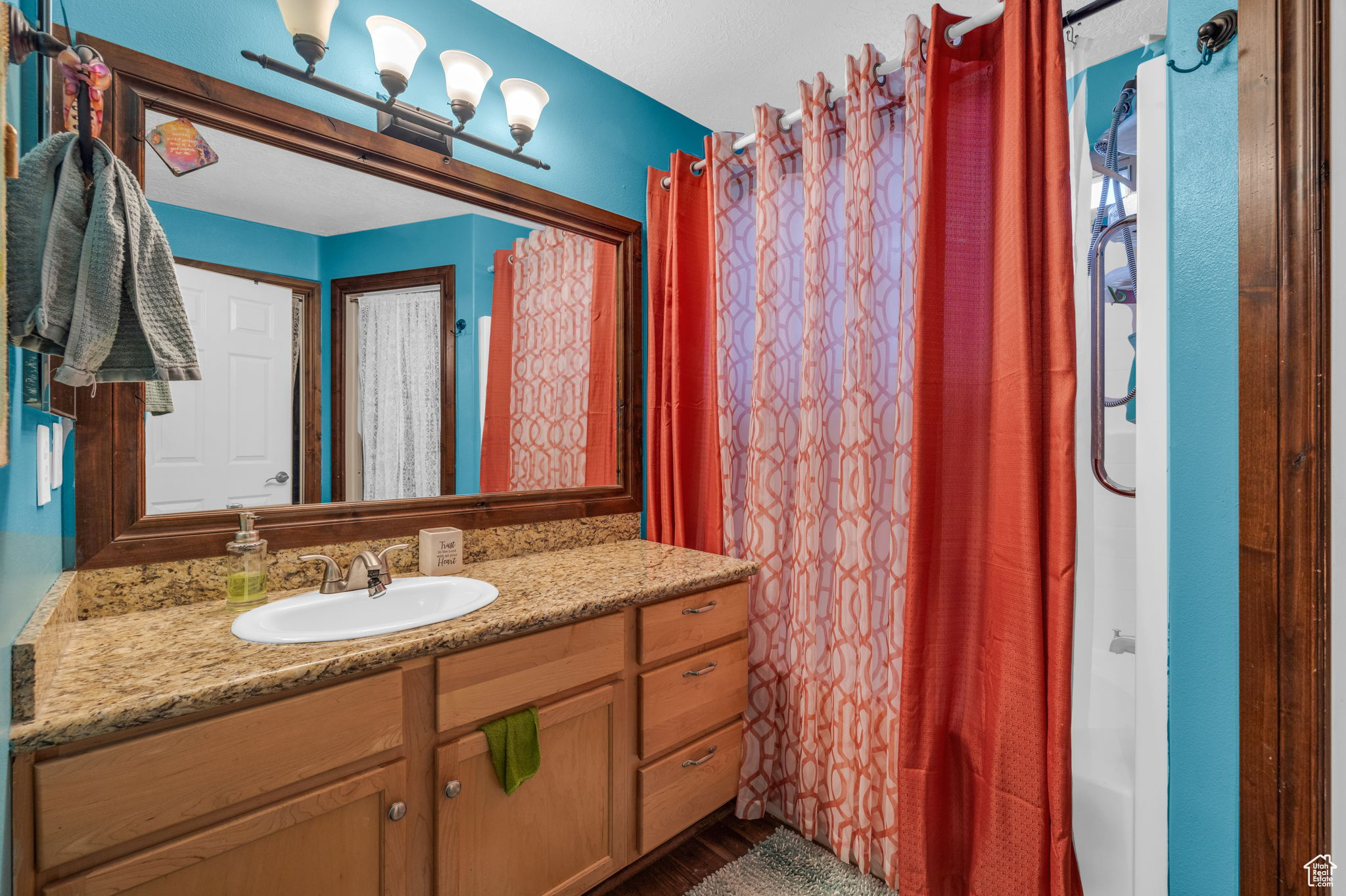 Bathroom featuring vanity and curtained shower