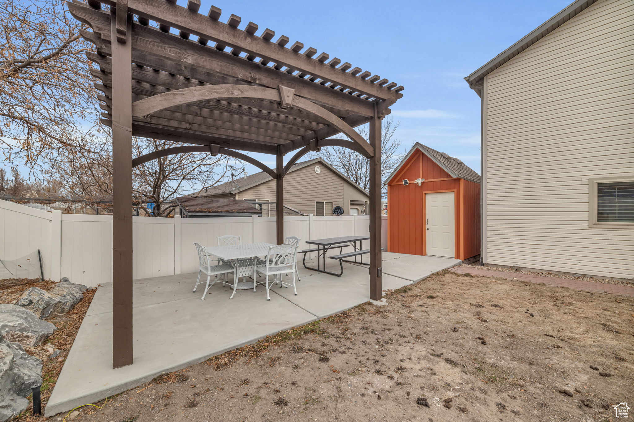 View of patio featuring a storage shed and a pergola