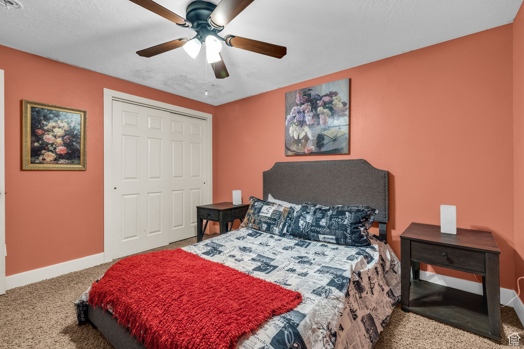 Bedroom with carpet flooring, a textured ceiling, ceiling fan, and a closet