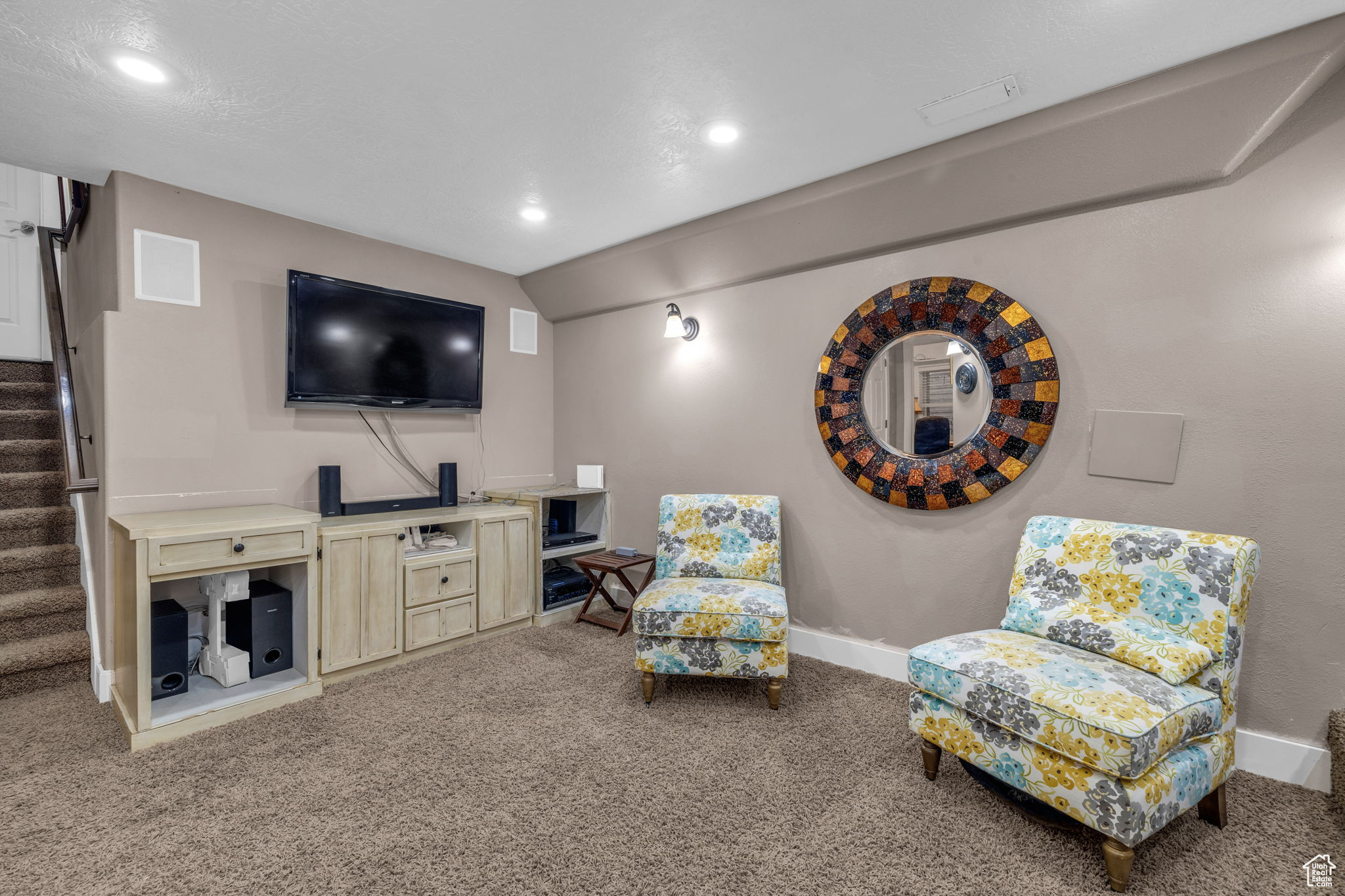 Living area with vaulted ceiling and carpet