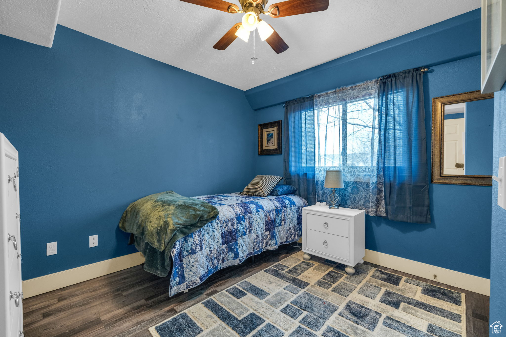 Bedroom featuring dark hardwood / wood-style floors and ceiling fan