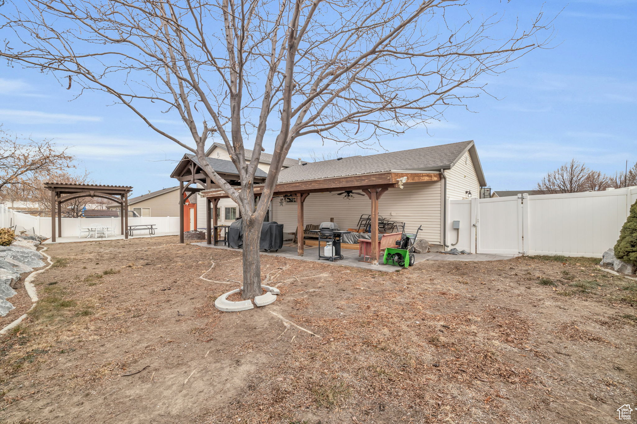 Rear view of house with a pergola and a patio