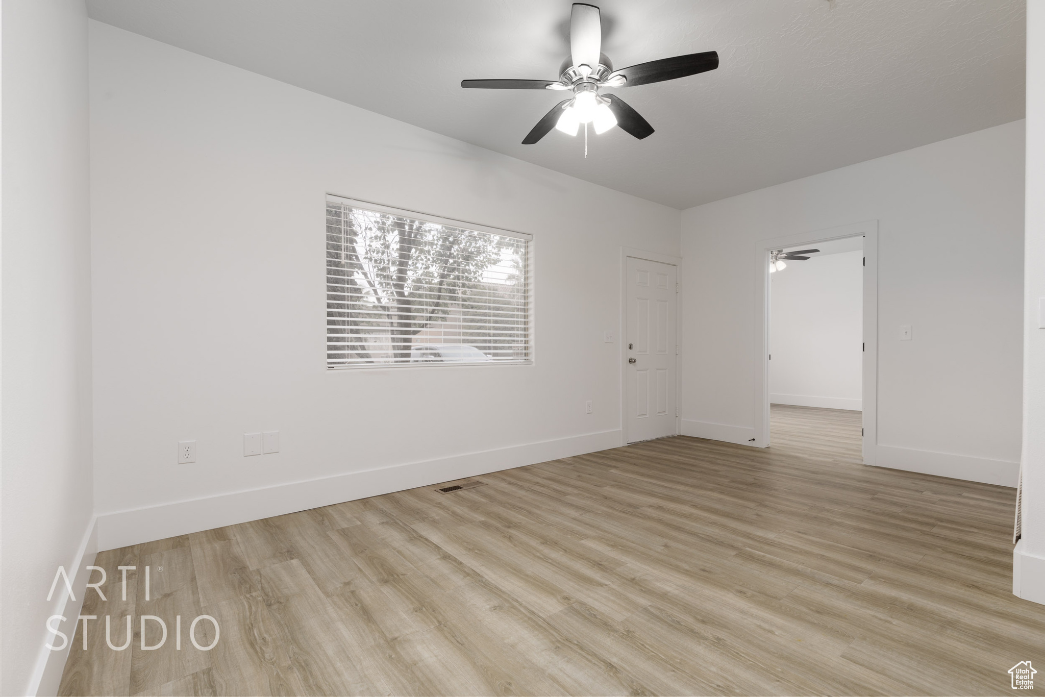 Empty room featuring ceiling fan and light hardwood / wood-style floors
