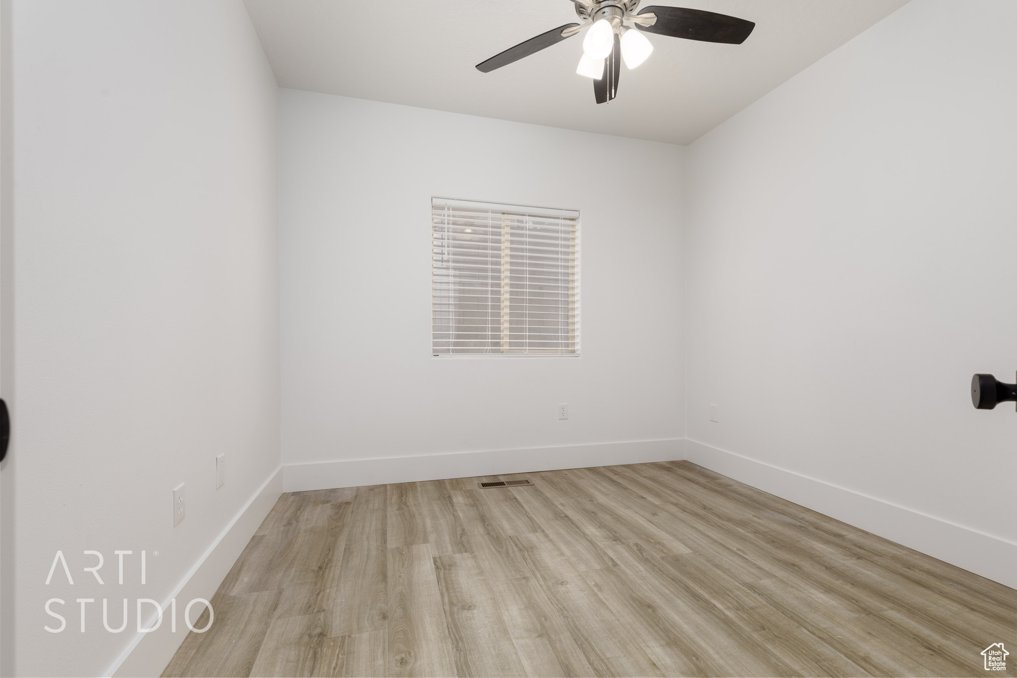 Spare room with ceiling fan and light wood-type flooring