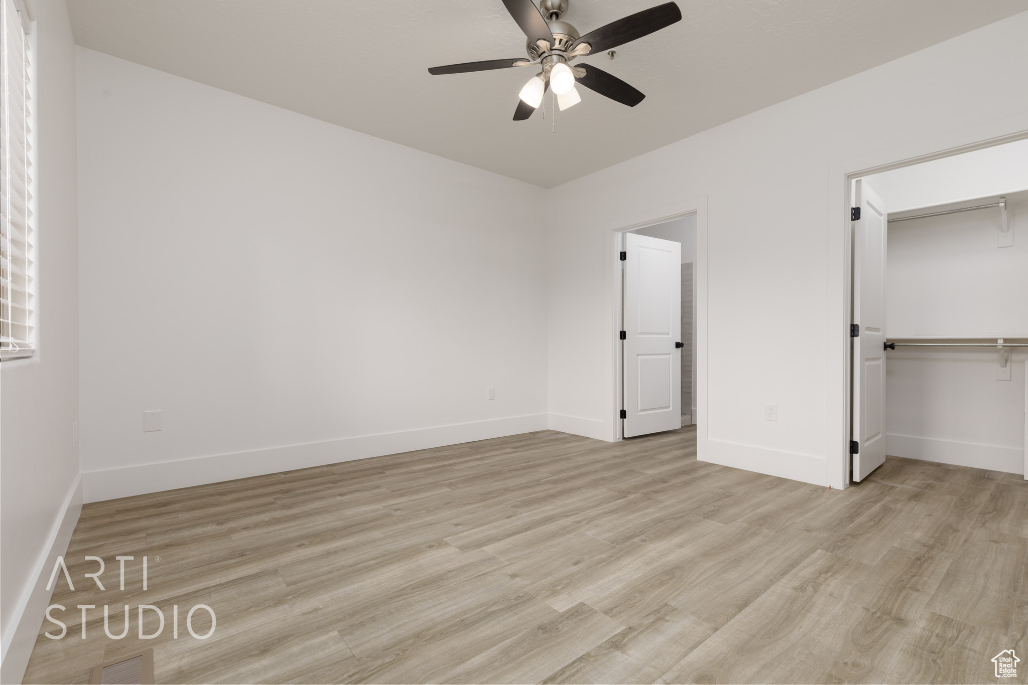 Unfurnished bedroom featuring light hardwood / wood-style flooring, a closet, and ceiling fan