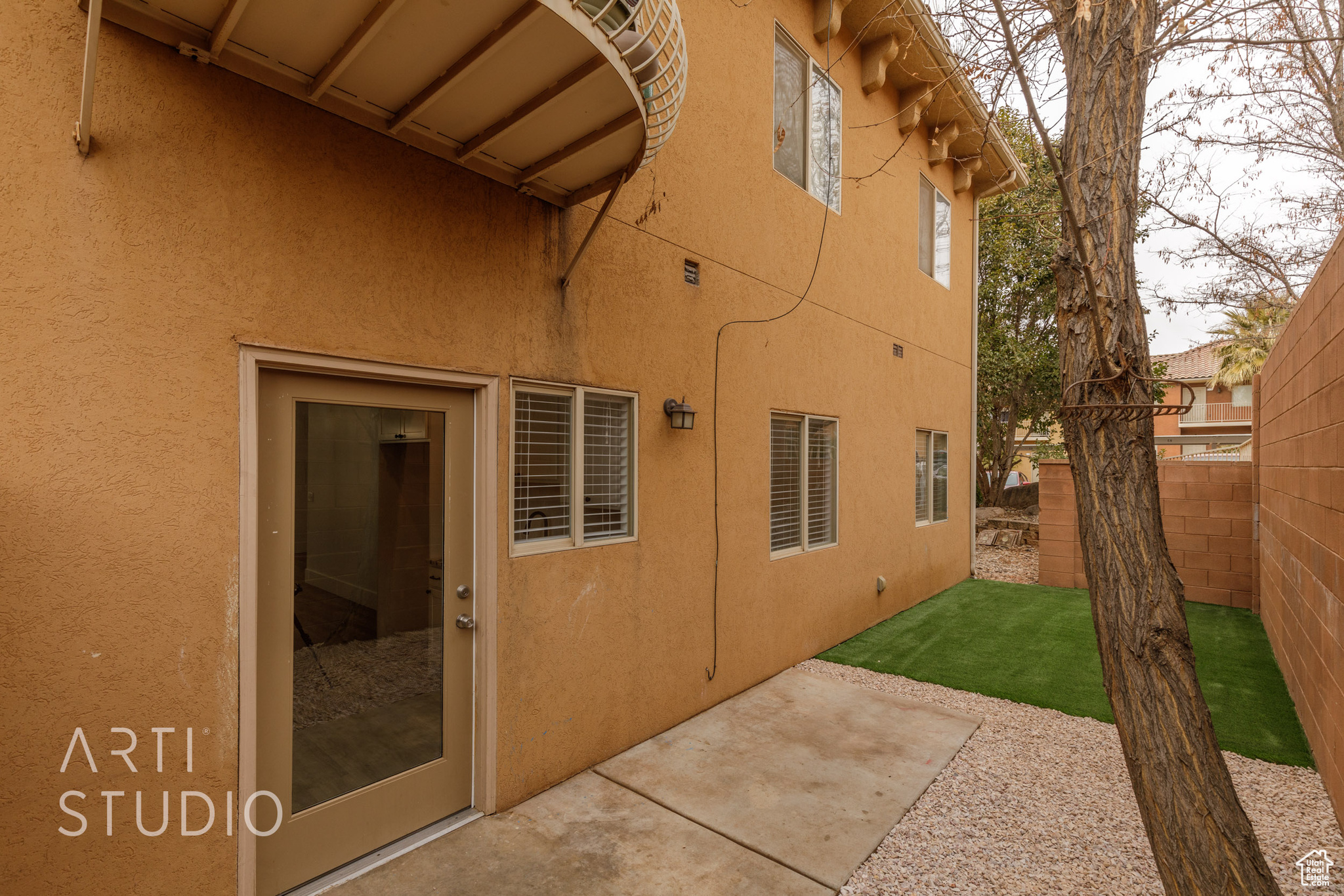 View of property exterior featuring a patio area and a lawn