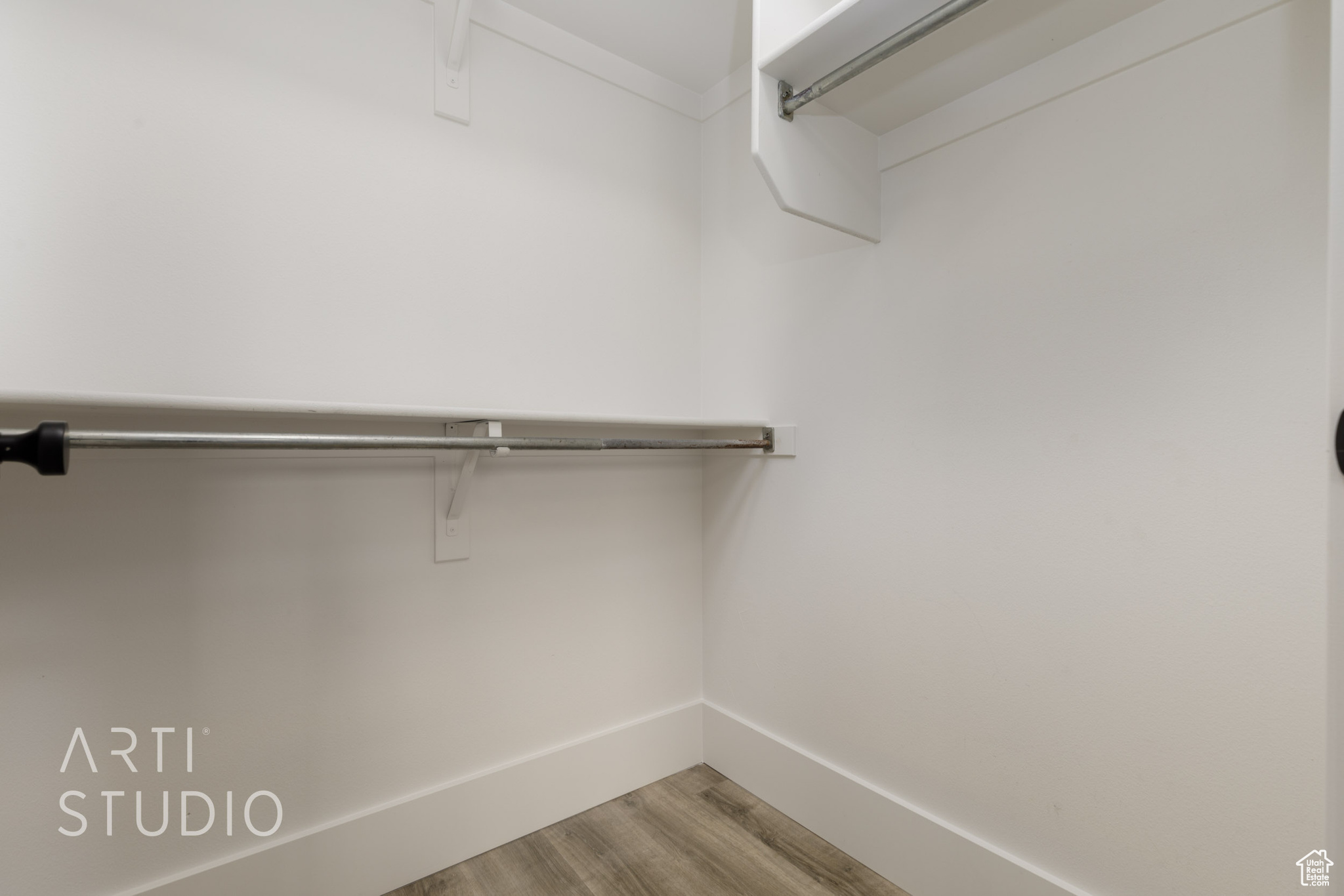 Spacious closet with hardwood / wood-style floors