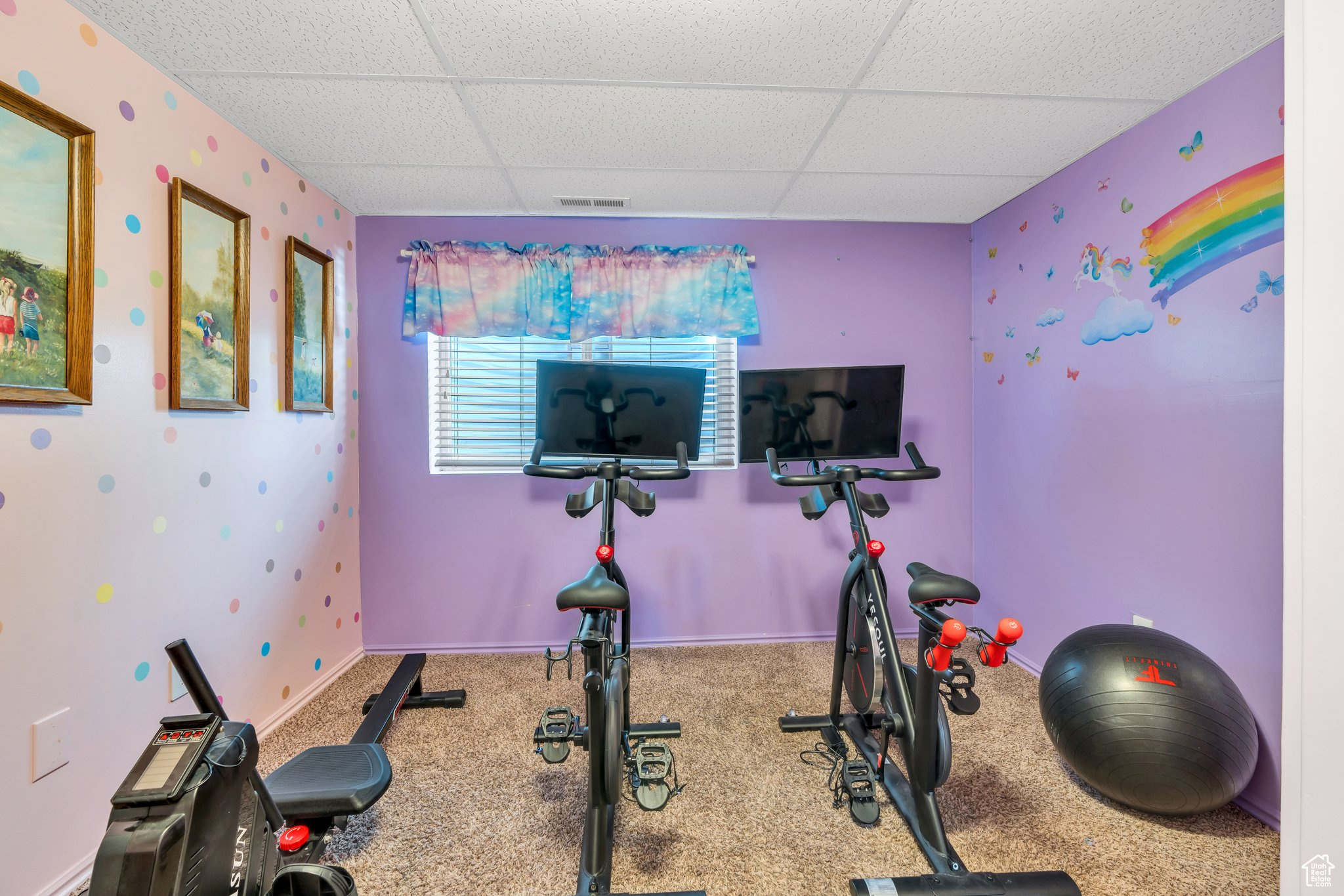 Workout area featuring carpet floors and a drop ceiling