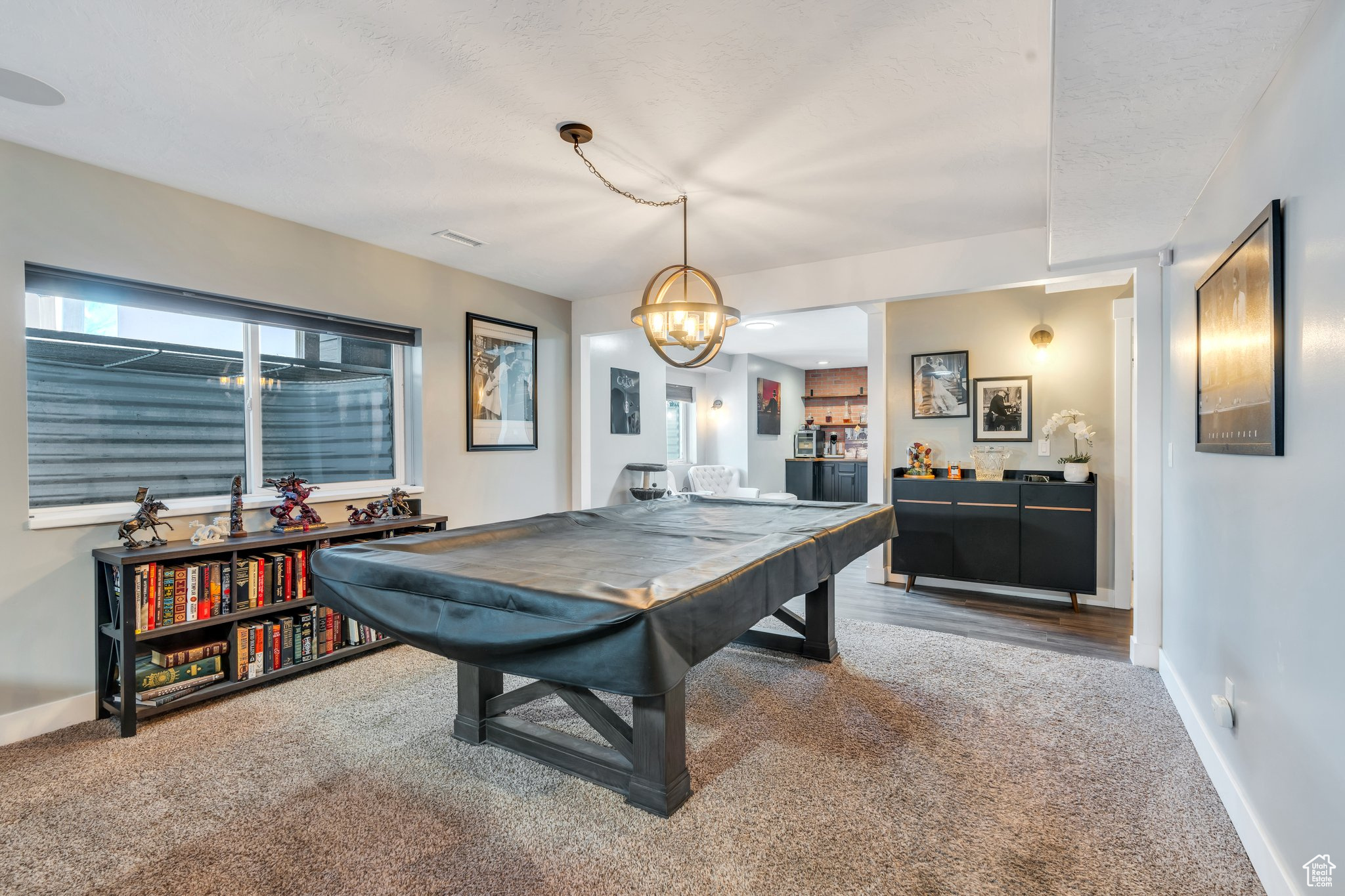 Game room with pool table, a textured ceiling, and carpet flooring