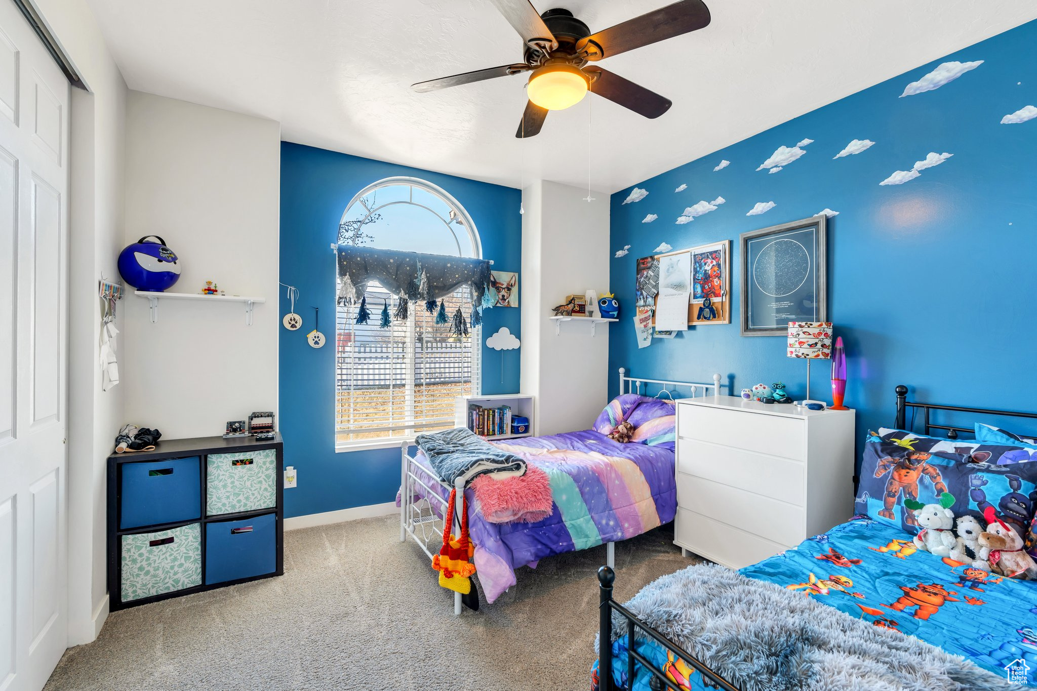 Carpeted bedroom featuring a closet and ceiling fan