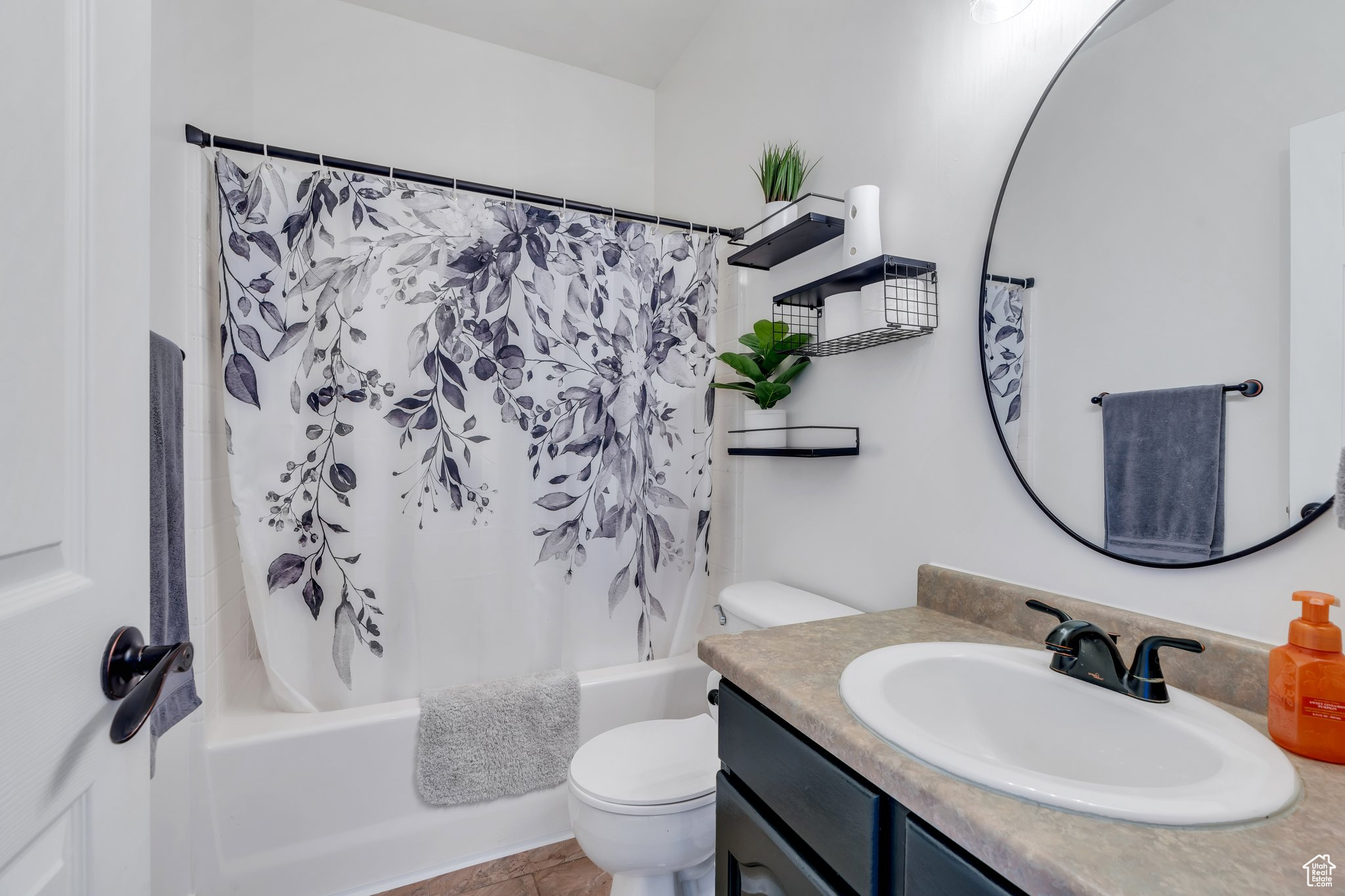 Full bathroom with shower / tub combo with curtain, vanity, and toilet