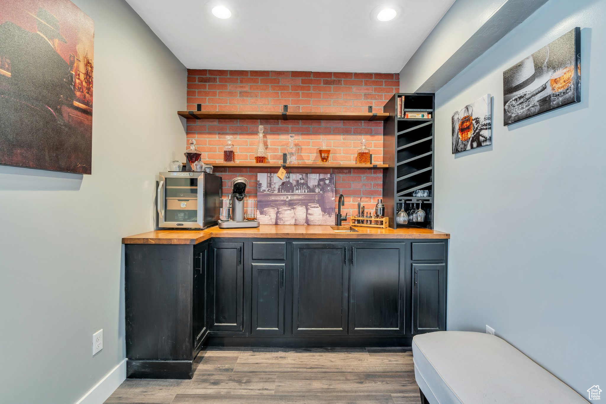 Bar with light wood-type flooring and butcher block countertops