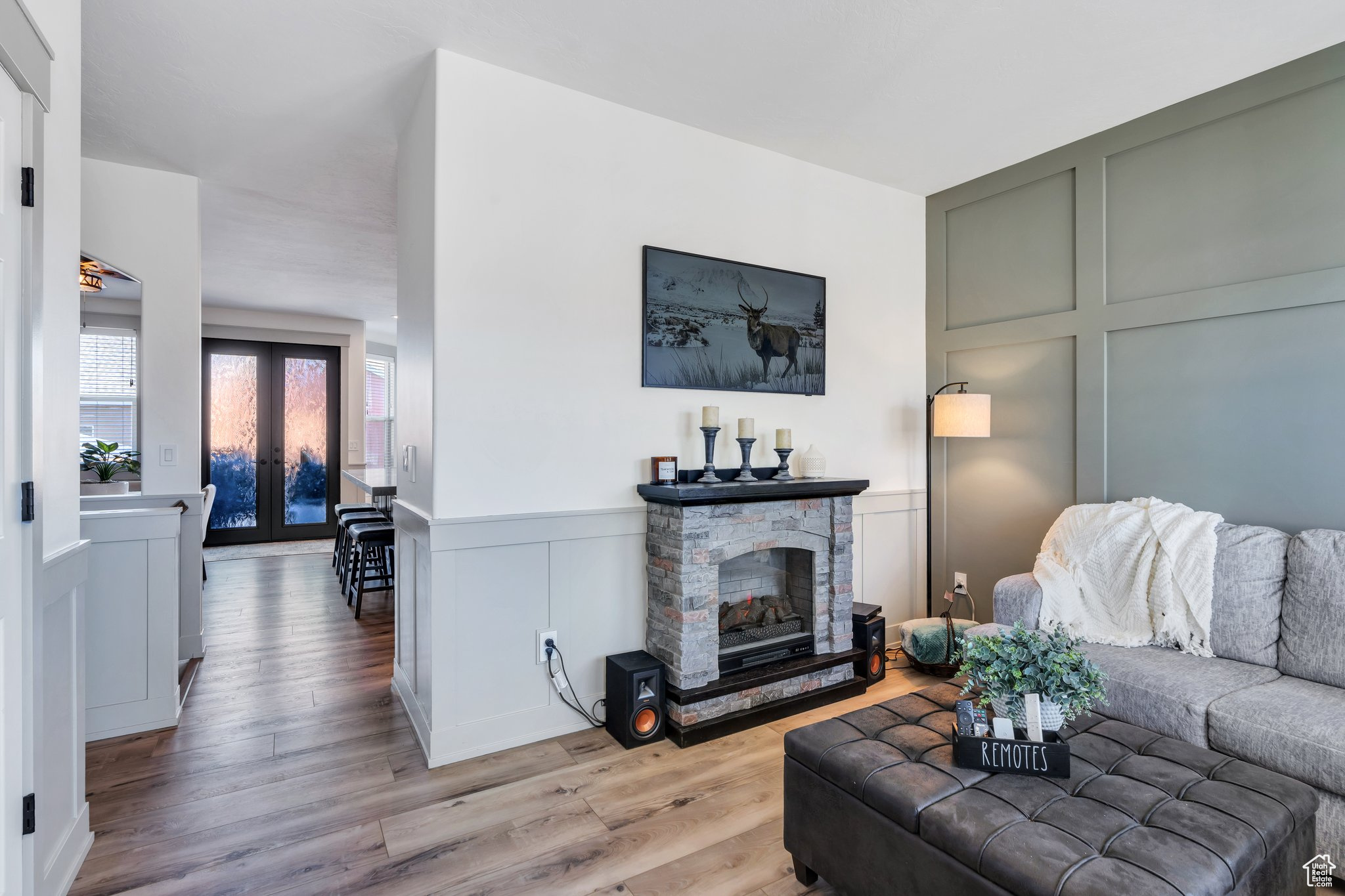 Living room featuring french doors, a fireplace, and light hardwood / wood-style floors