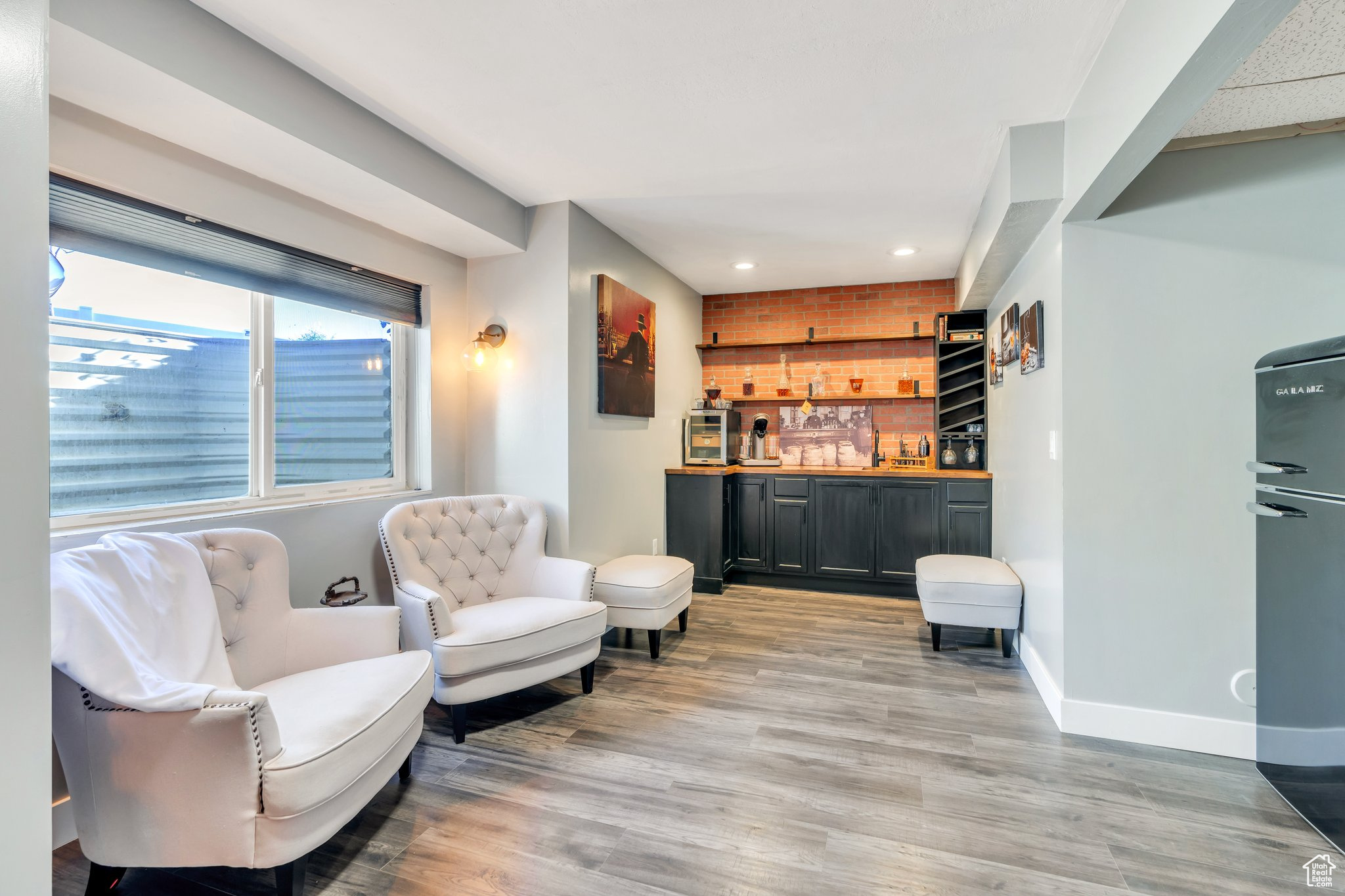 Living area with indoor bar and light hardwood / wood-style floors