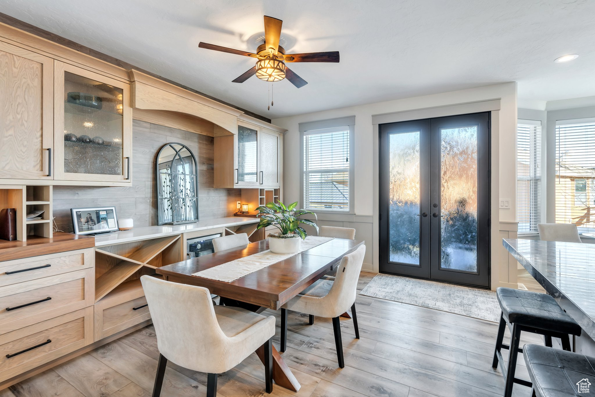 Dining area with french doors, a healthy amount of sunlight, and light wood-type flooring