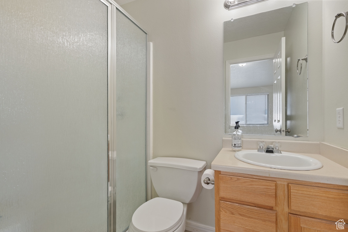 Bathroom with vanity, toilet, and walk in shower