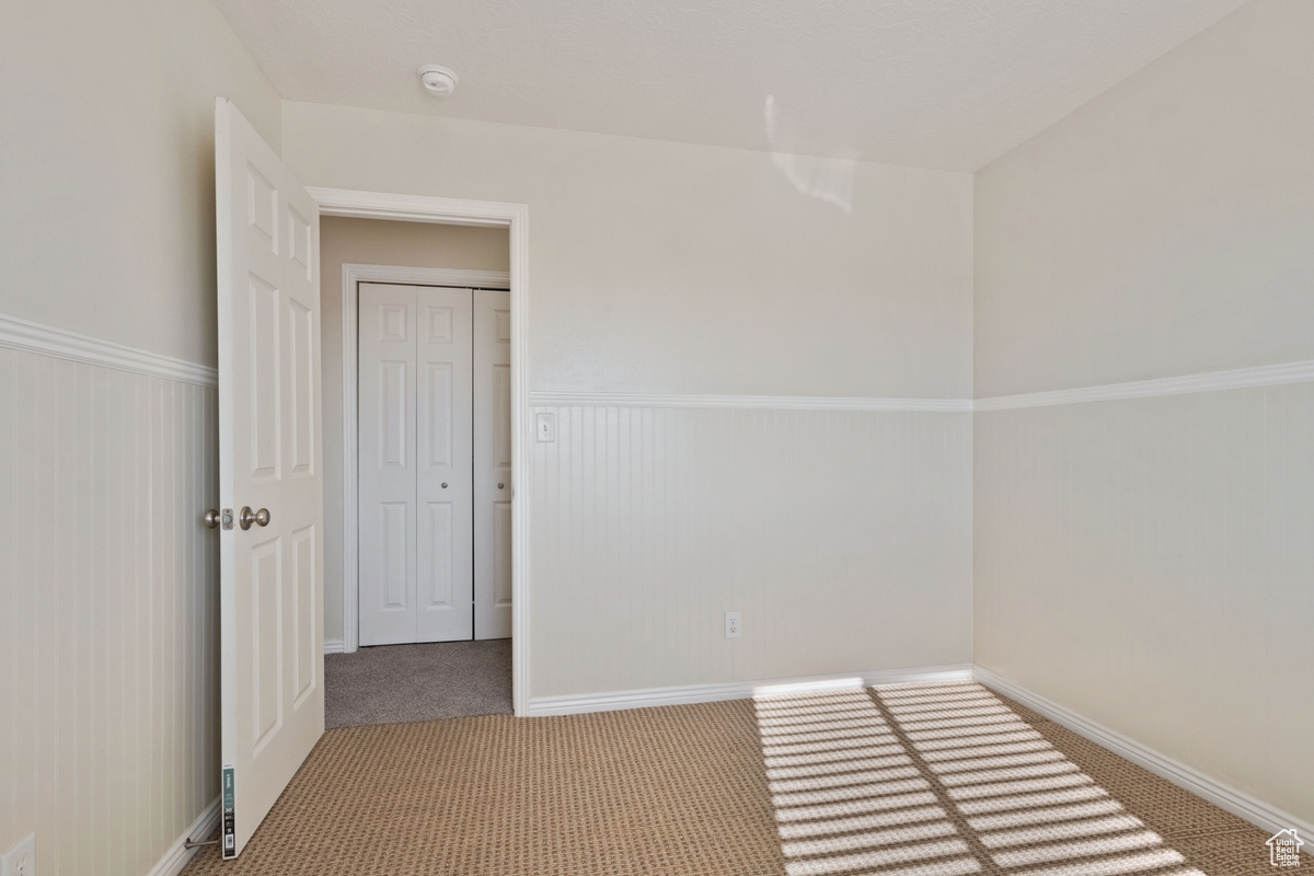 Empty room with carpet flooring