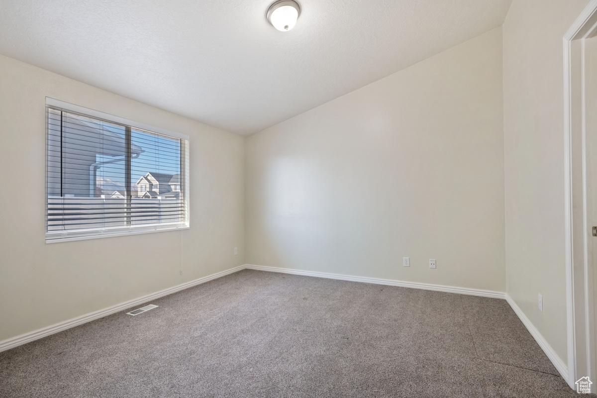 Unfurnished room with carpet