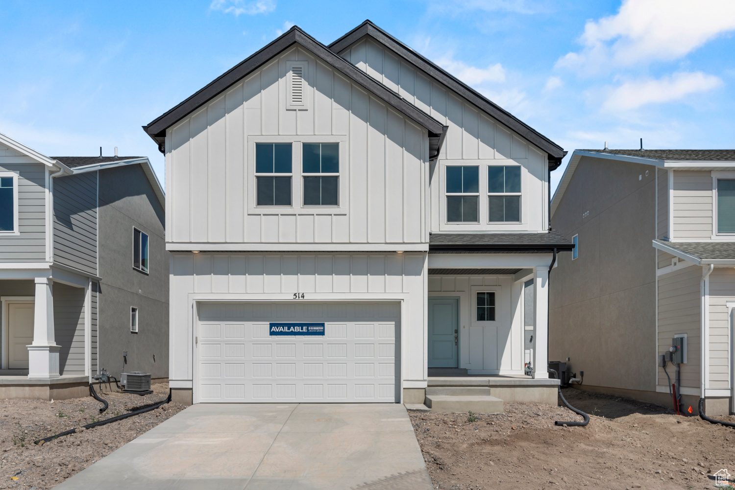 View of front facade featuring a garage and central AC