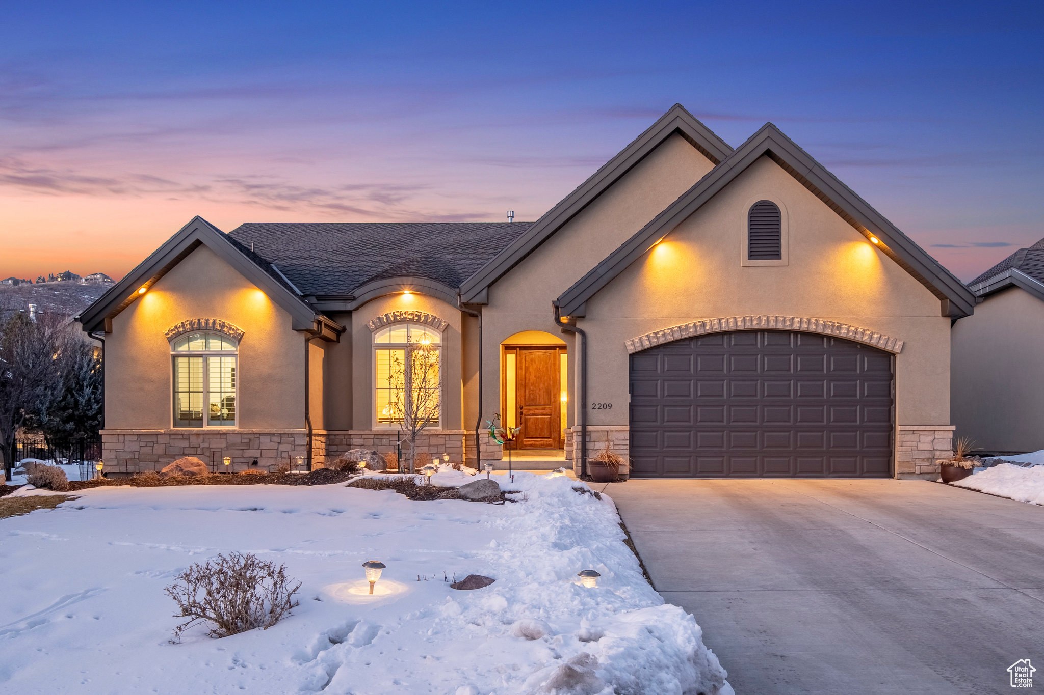 French country inspired facade with a garage