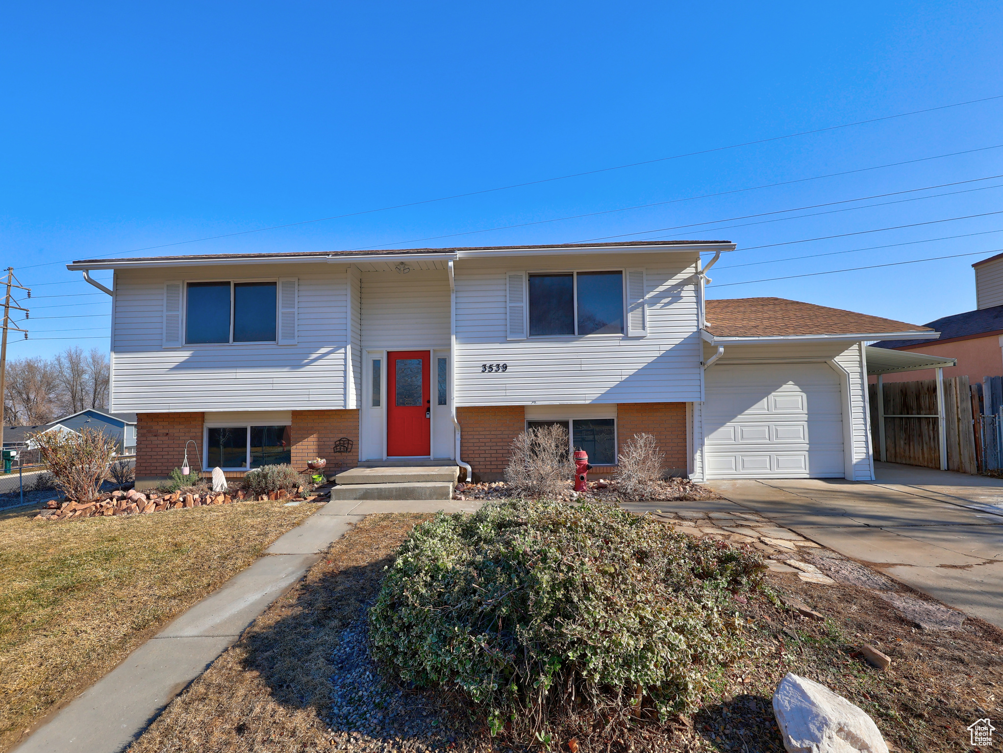 Split foyer home with a garage and a carport