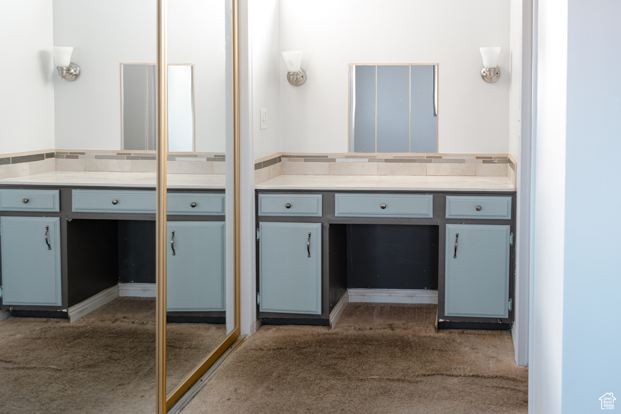 Bathroom featuring vanity and decorative backsplash