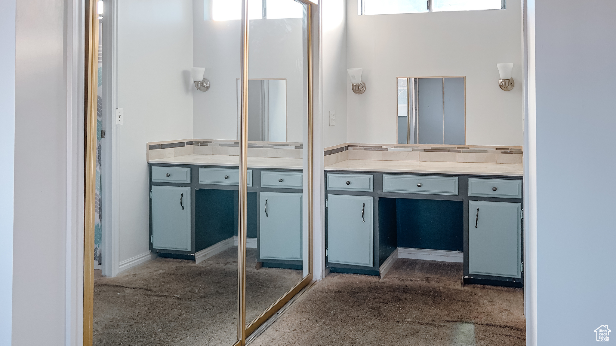 Bathroom featuring a towering ceiling and vanity