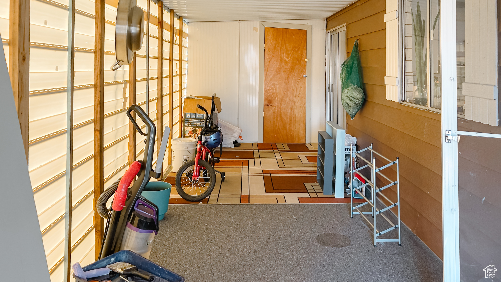 Misc room with carpet floors and wood walls