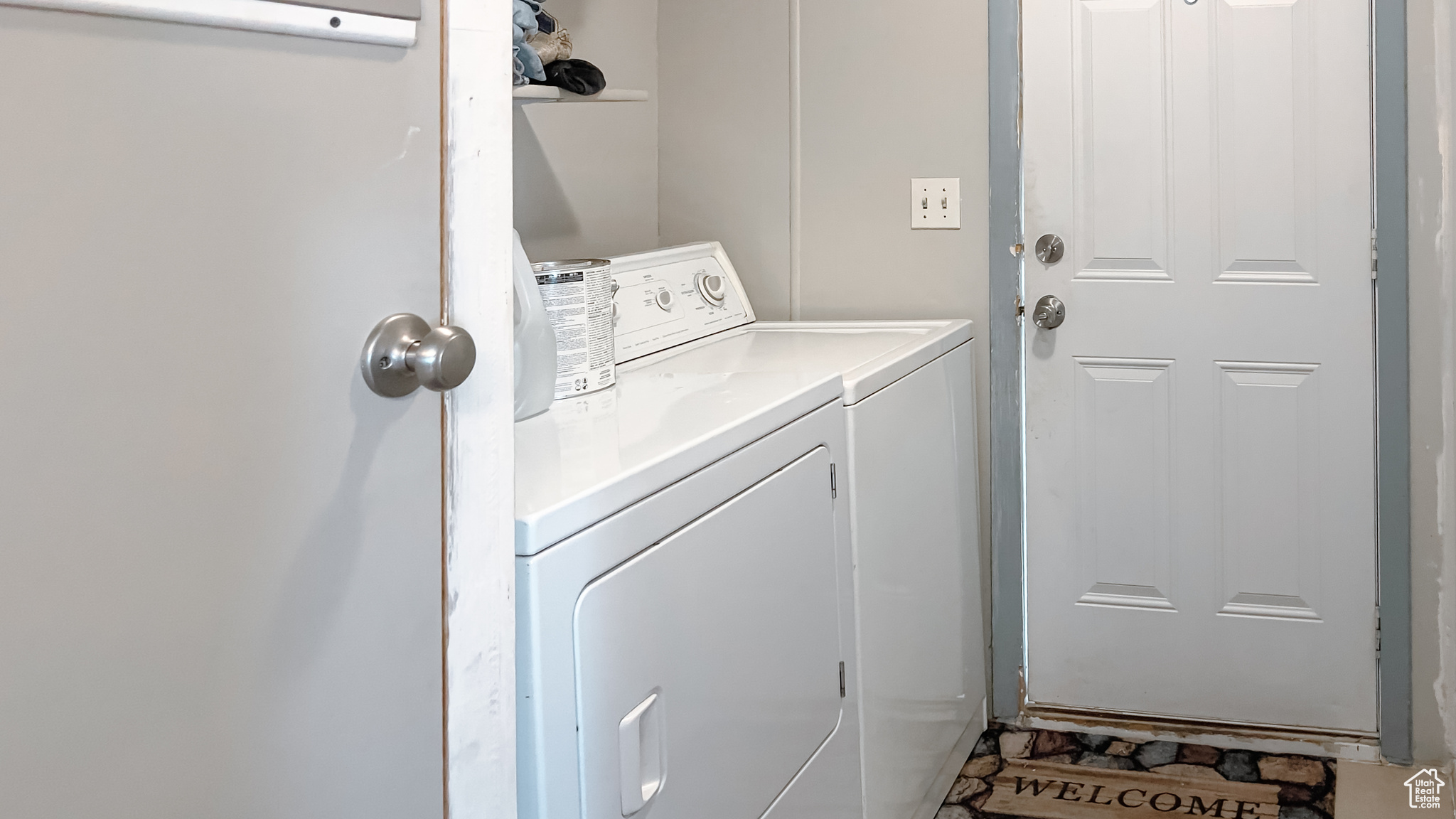 Clothes washing area featuring washer and dryer