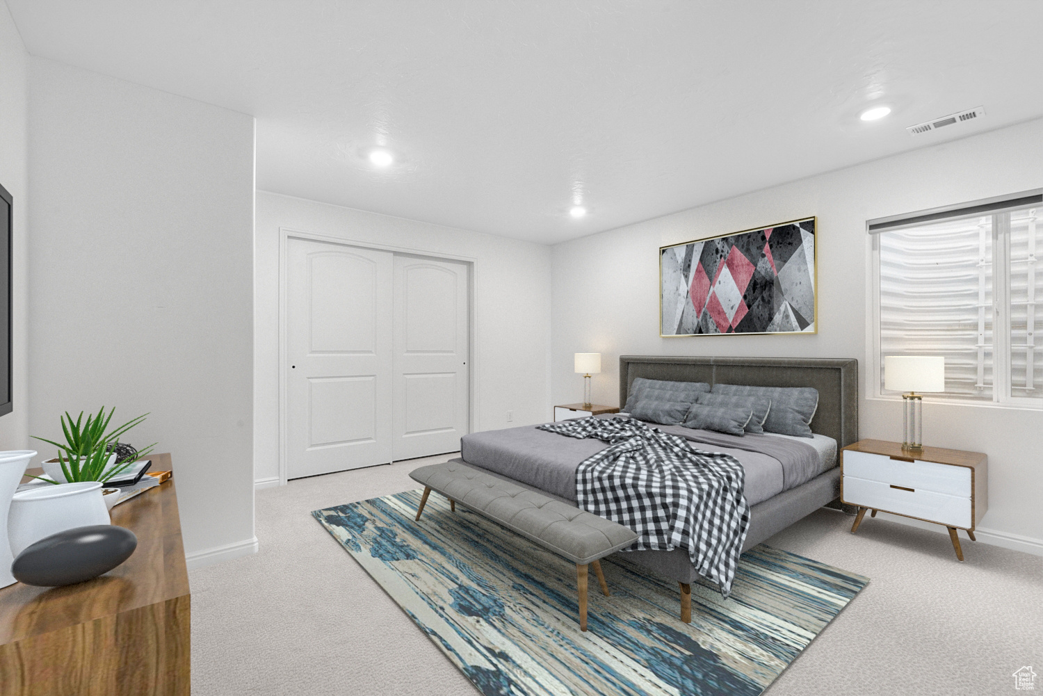 Bedroom with light colored carpet and a closet