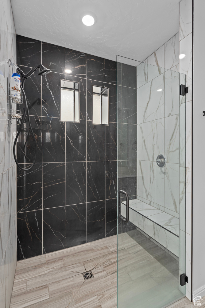 Bathroom featuring a shower with door