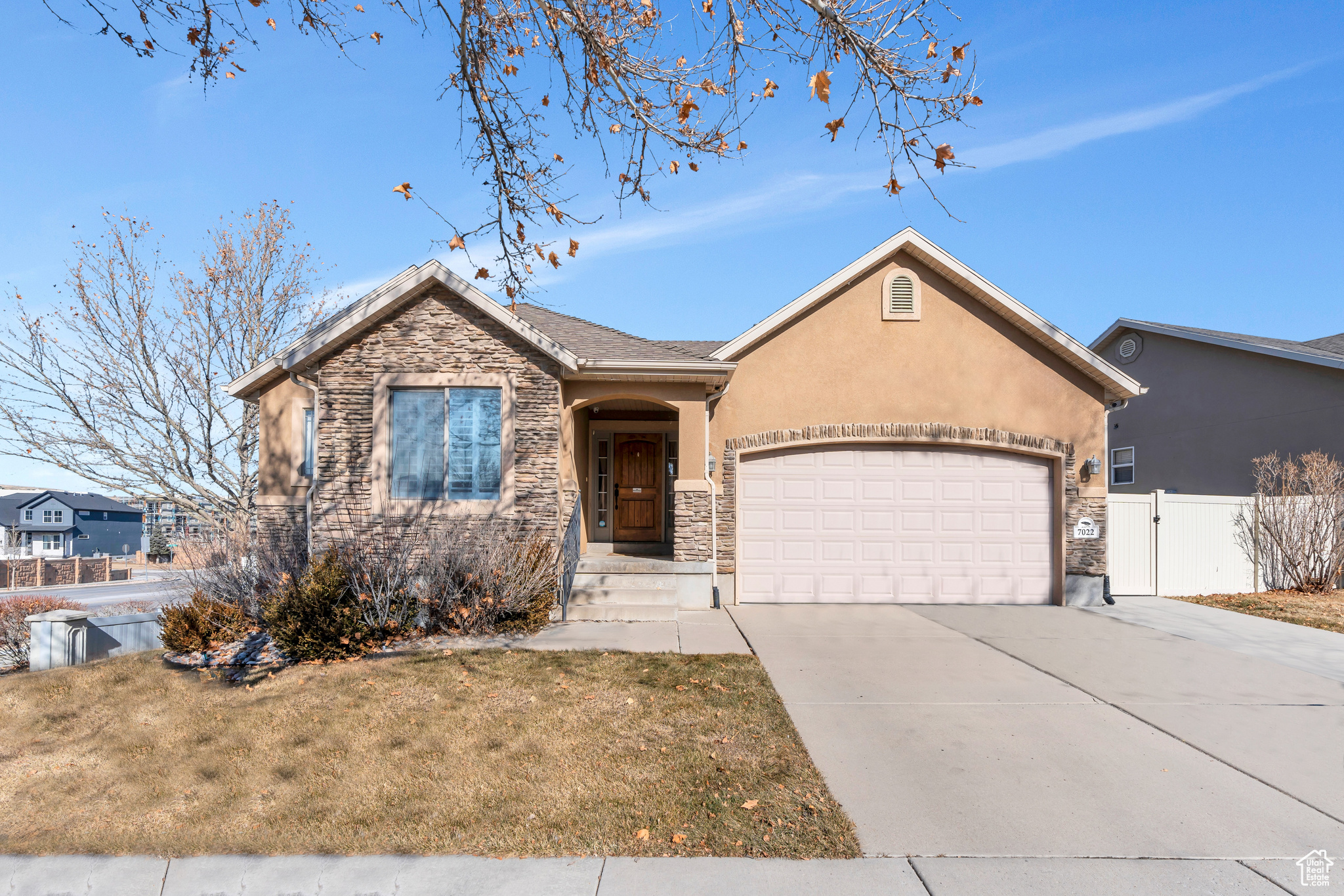 View of front of home featuring a garage and a front yard