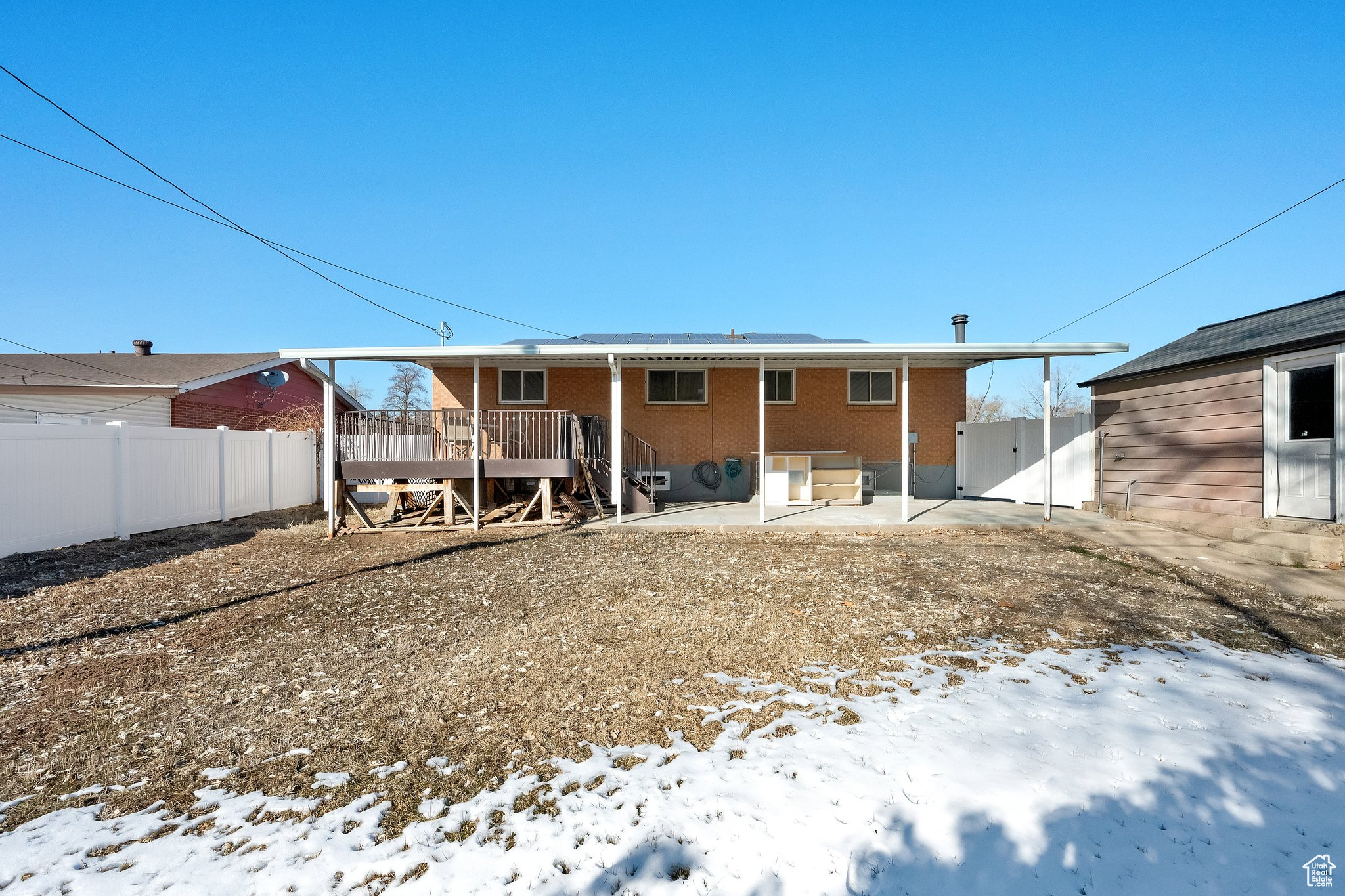 Snow covered property with a wooden deck