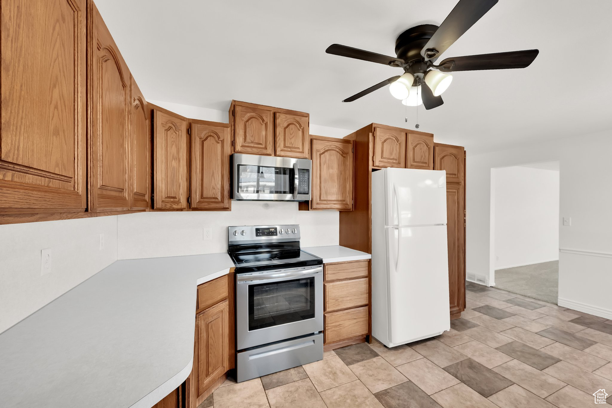 Kitchen with ceiling fan and stainless steel appliances