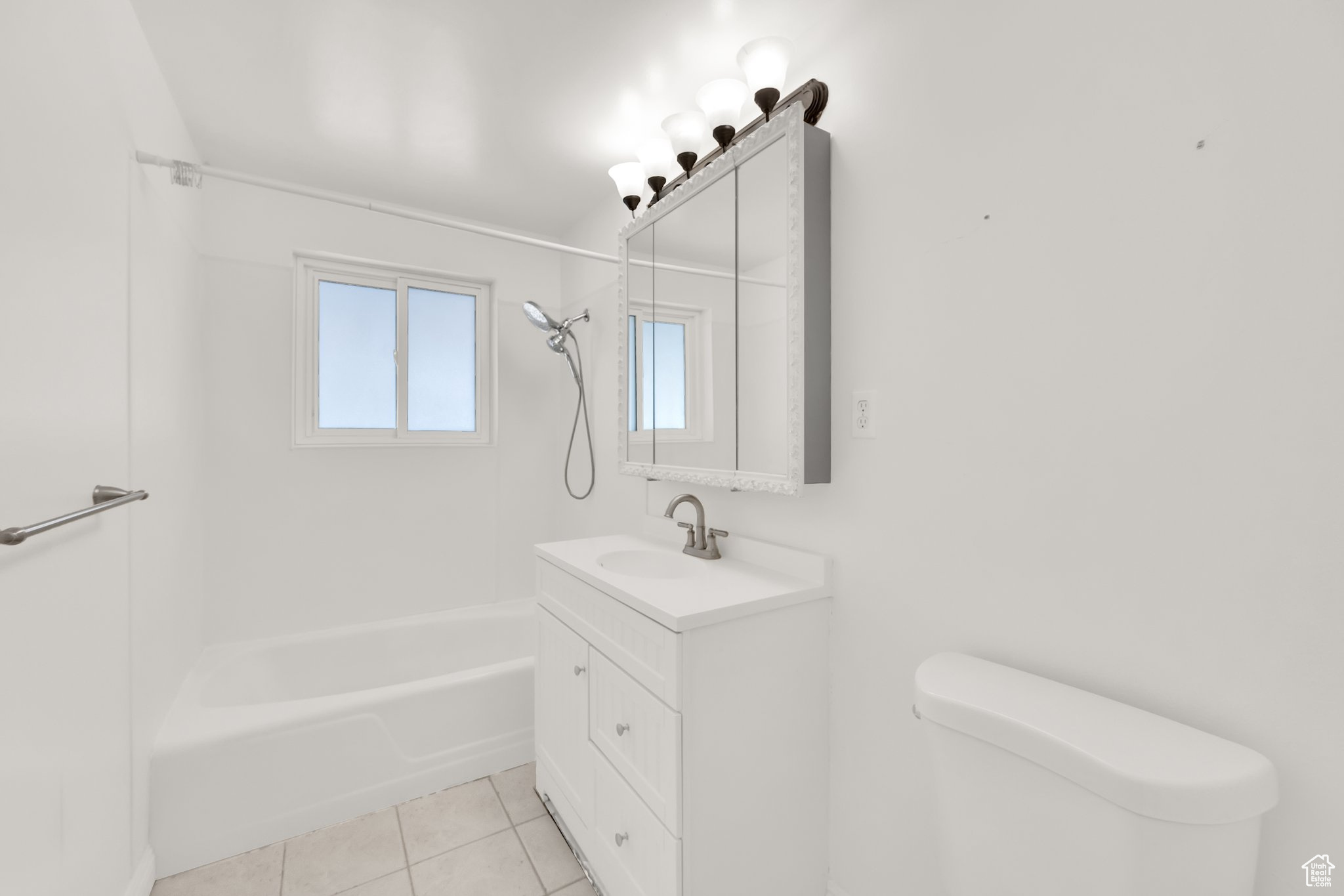 Full bathroom featuring vanity, tile patterned floors, bathing tub / shower combination, and toilet