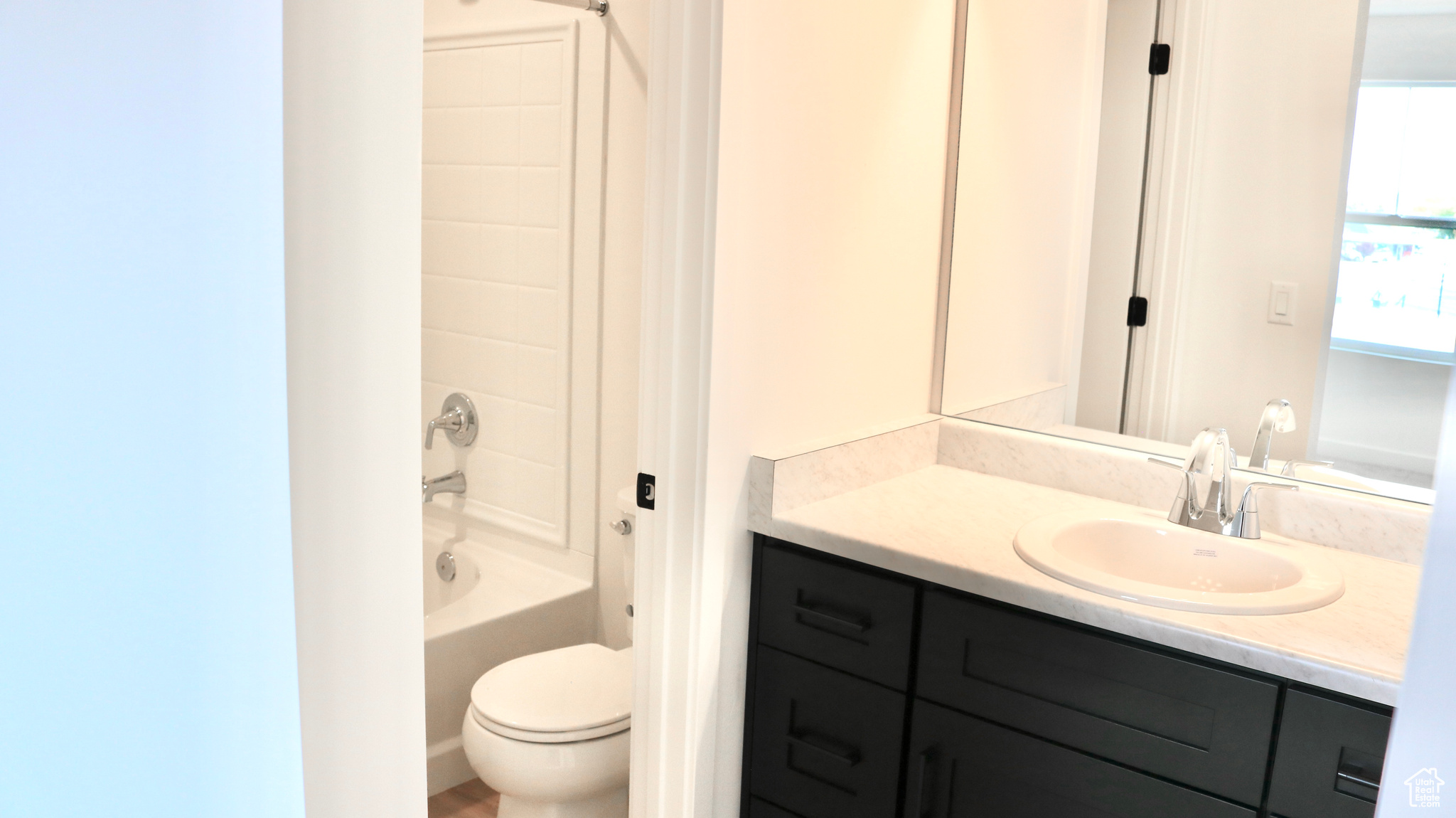 Full bathroom with shower / washtub combination, toilet, and vanity