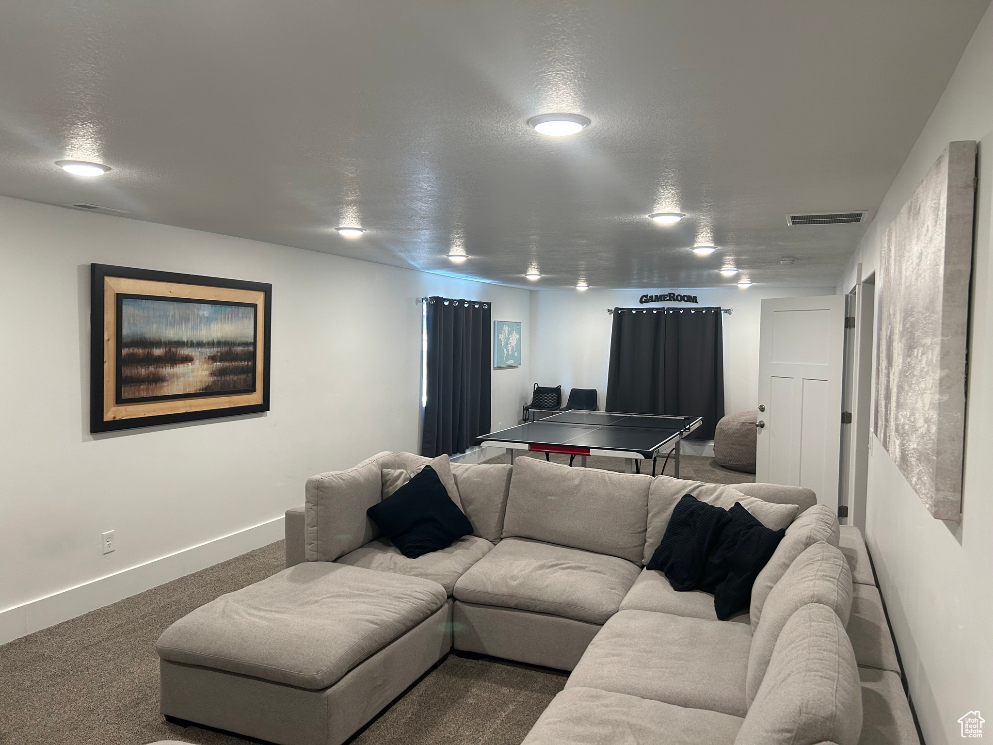 Living room with carpet flooring and a textured ceiling