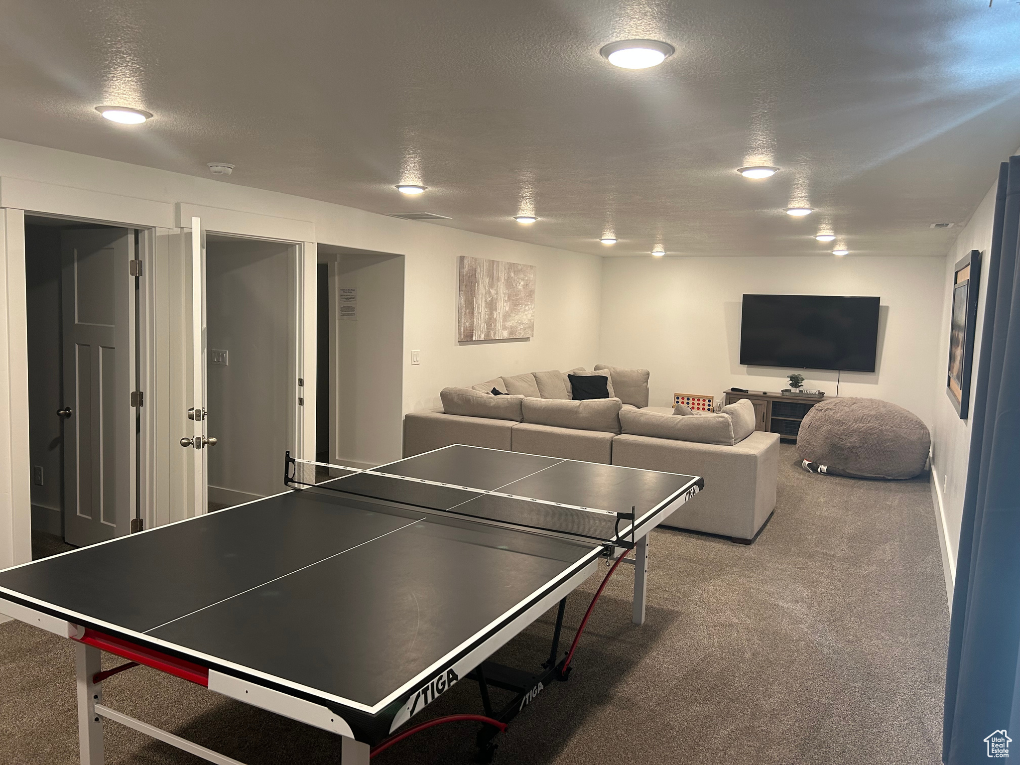 Playroom featuring carpet floors and a textured ceiling