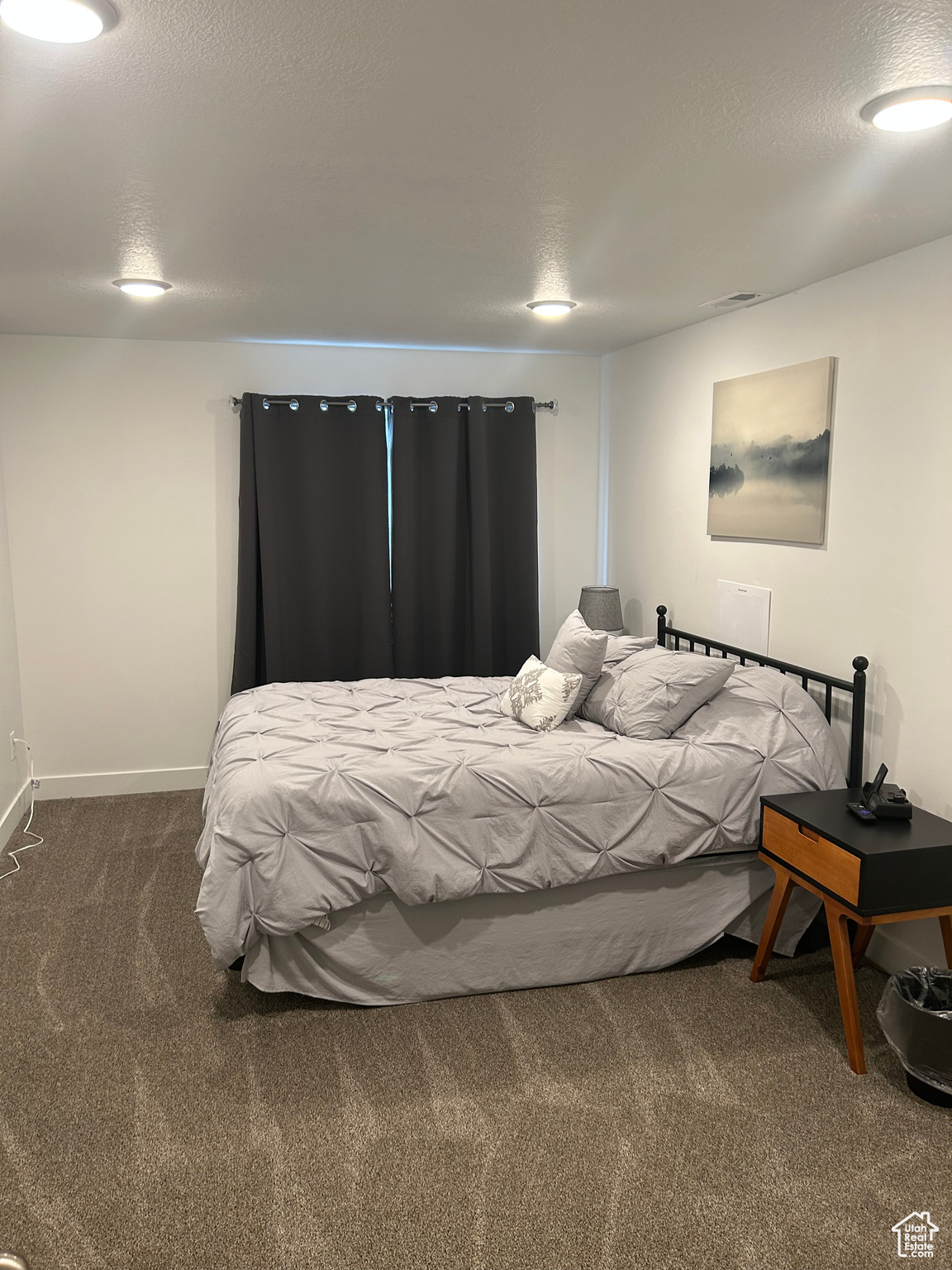 Carpeted bedroom with a textured ceiling