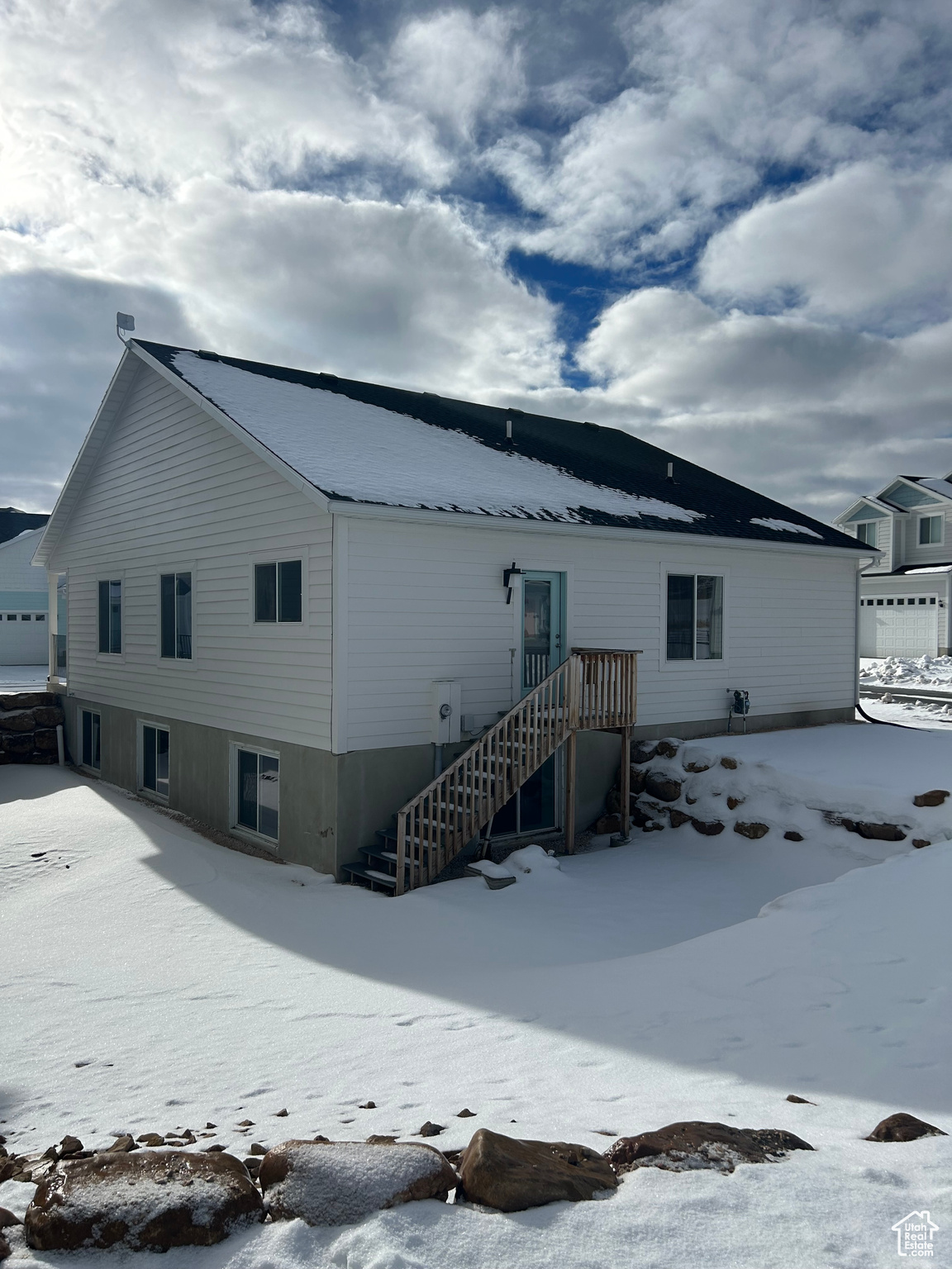 View of snow covered rear of property